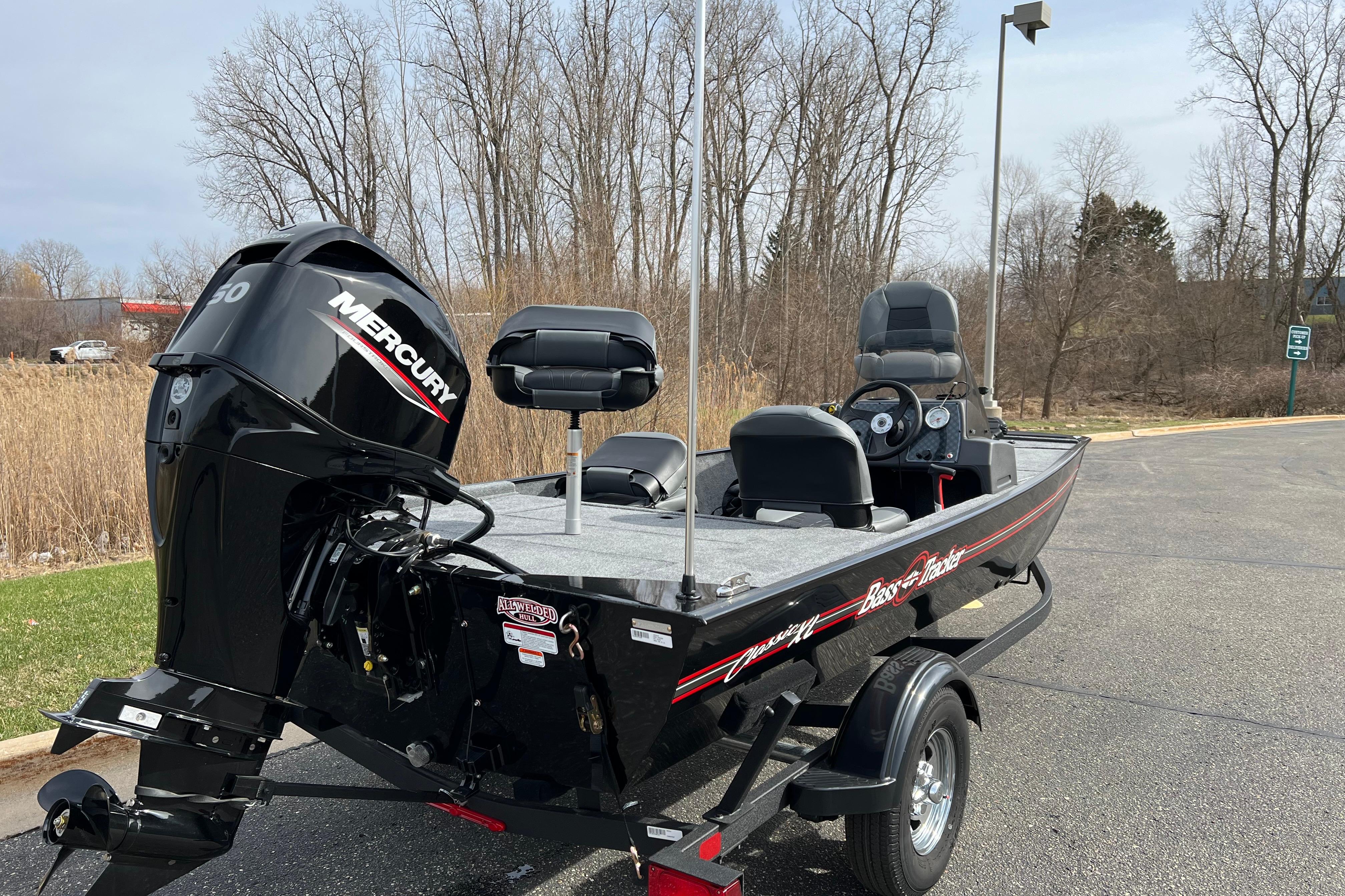 2026 Tracker Bass Tracker Classic XL boat with Mercury engine, parked outdoors.
