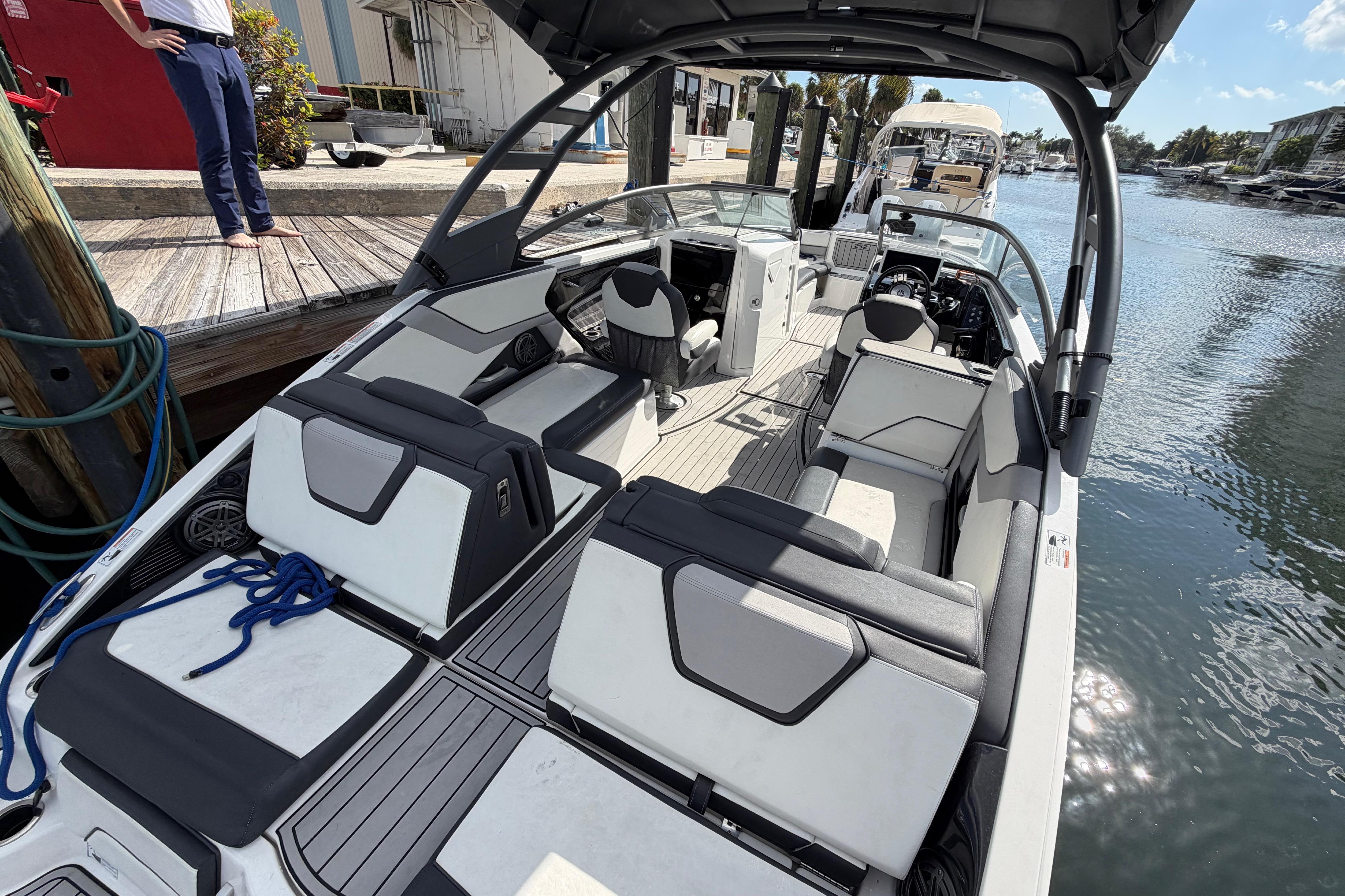 2022 Yamaha Boats 252SD interior view at dock, showcasing seating and helm.