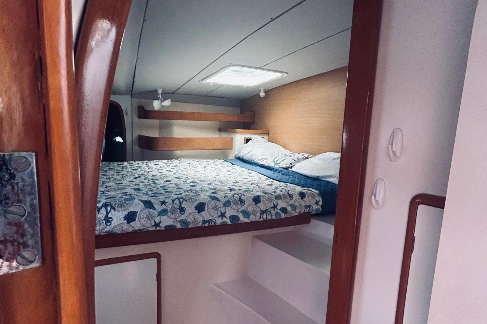 Cozy cabin interior of 2001 Robertson & Caine Leopard yacht with patterned bedding.