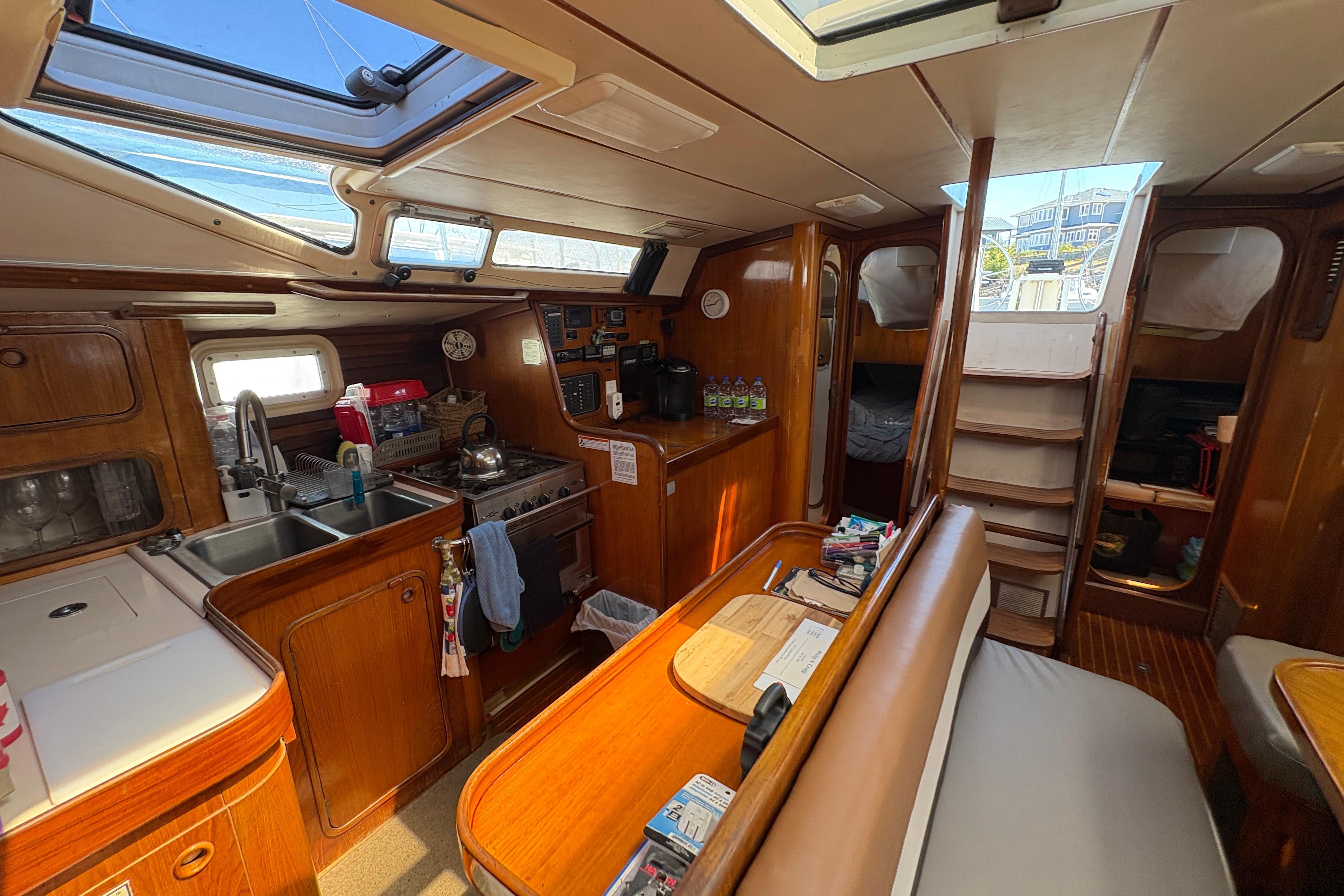 Interior of 1990 Beneteau Oceanis 500 sailboat with kitchen and seating area.