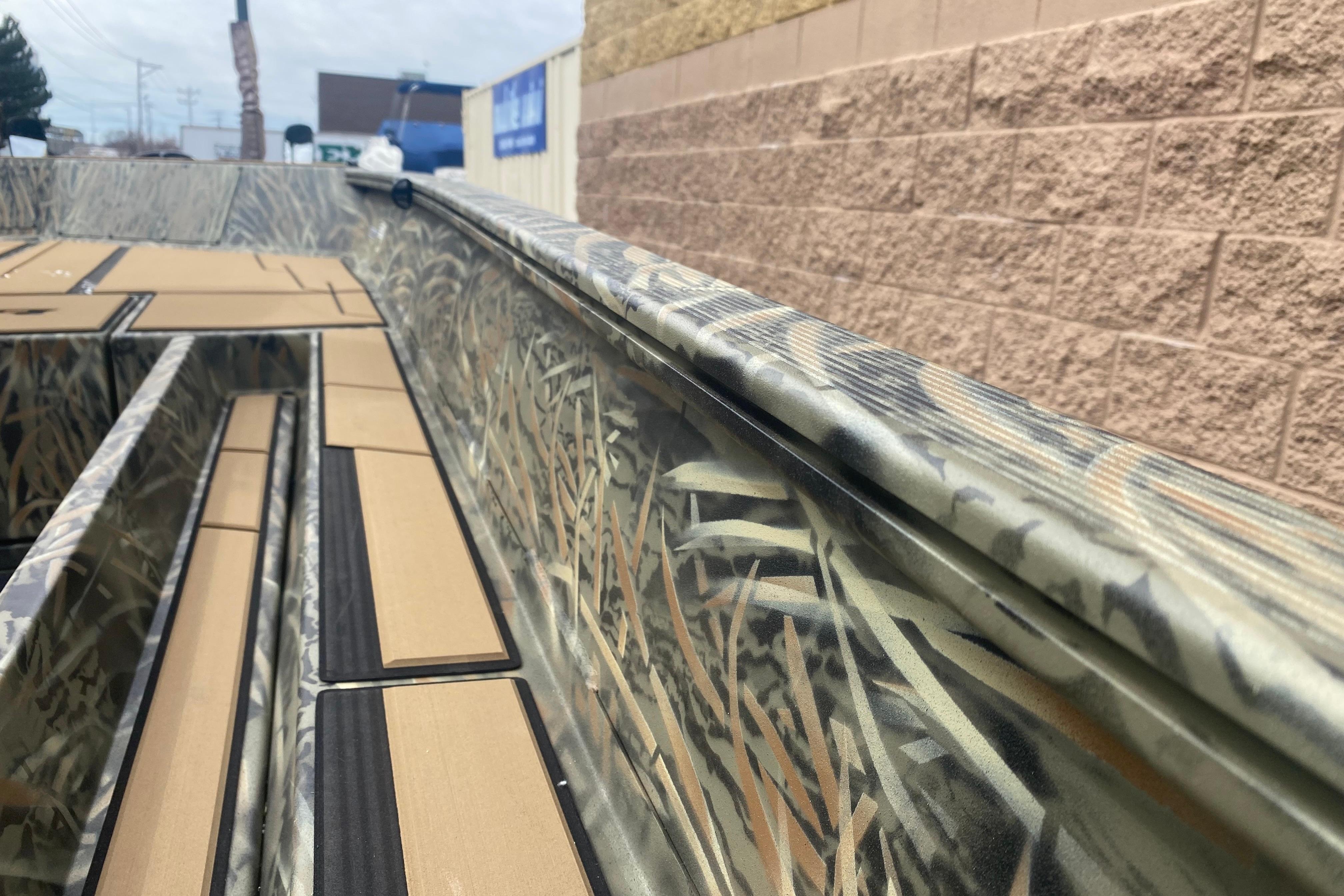 2026 Tracker Grizzly 1756 T Marsh boat with camouflage design and padded interior.