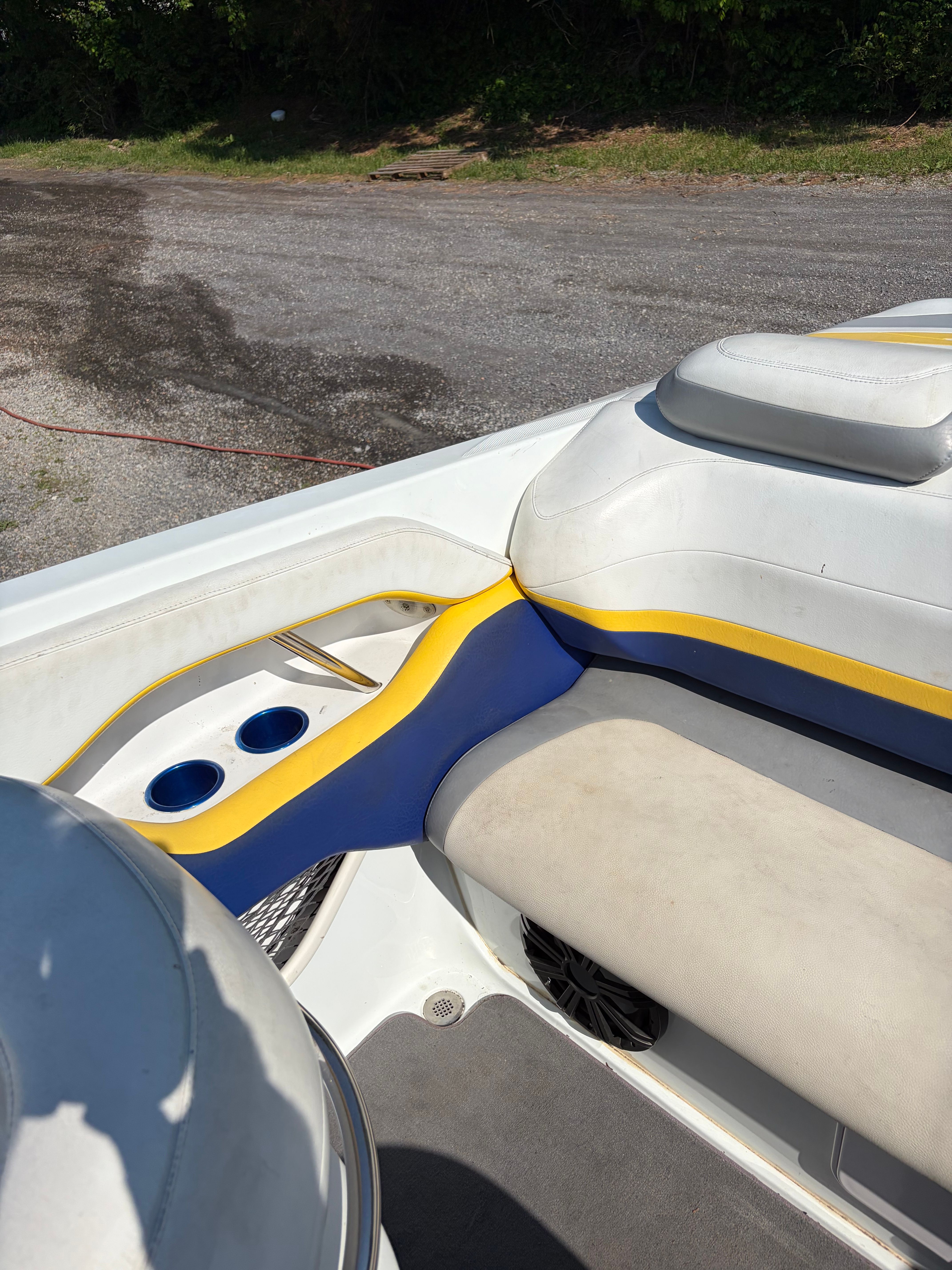 Interior of a 2007 Baja 30 Outlaw boat with blue and yellow accents.