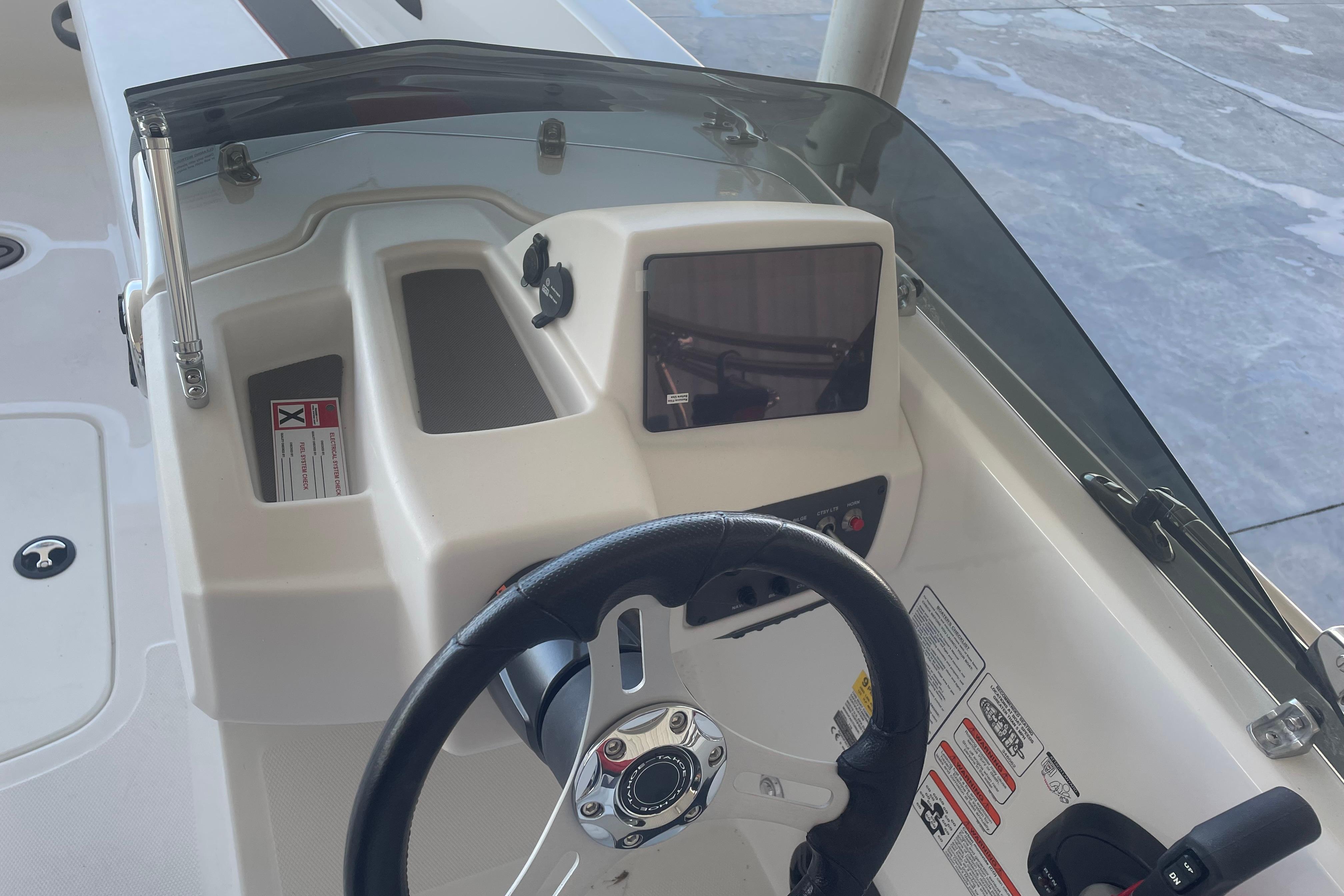 2026 Tahoe T18 boat dashboard with steering wheel and control panel.