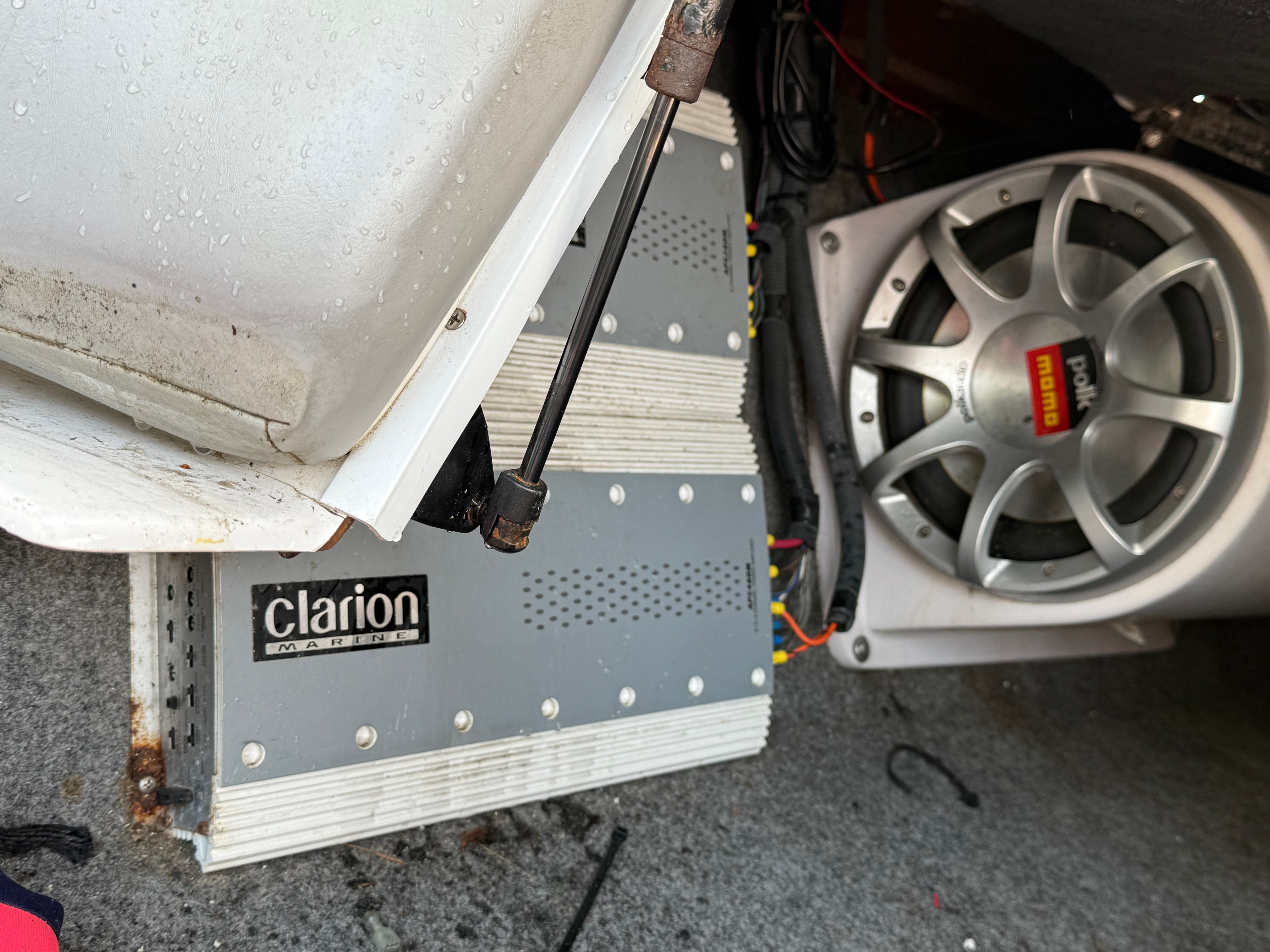 A Clarion amplifier and a Polk Audio subwoofer are installed in the boat.