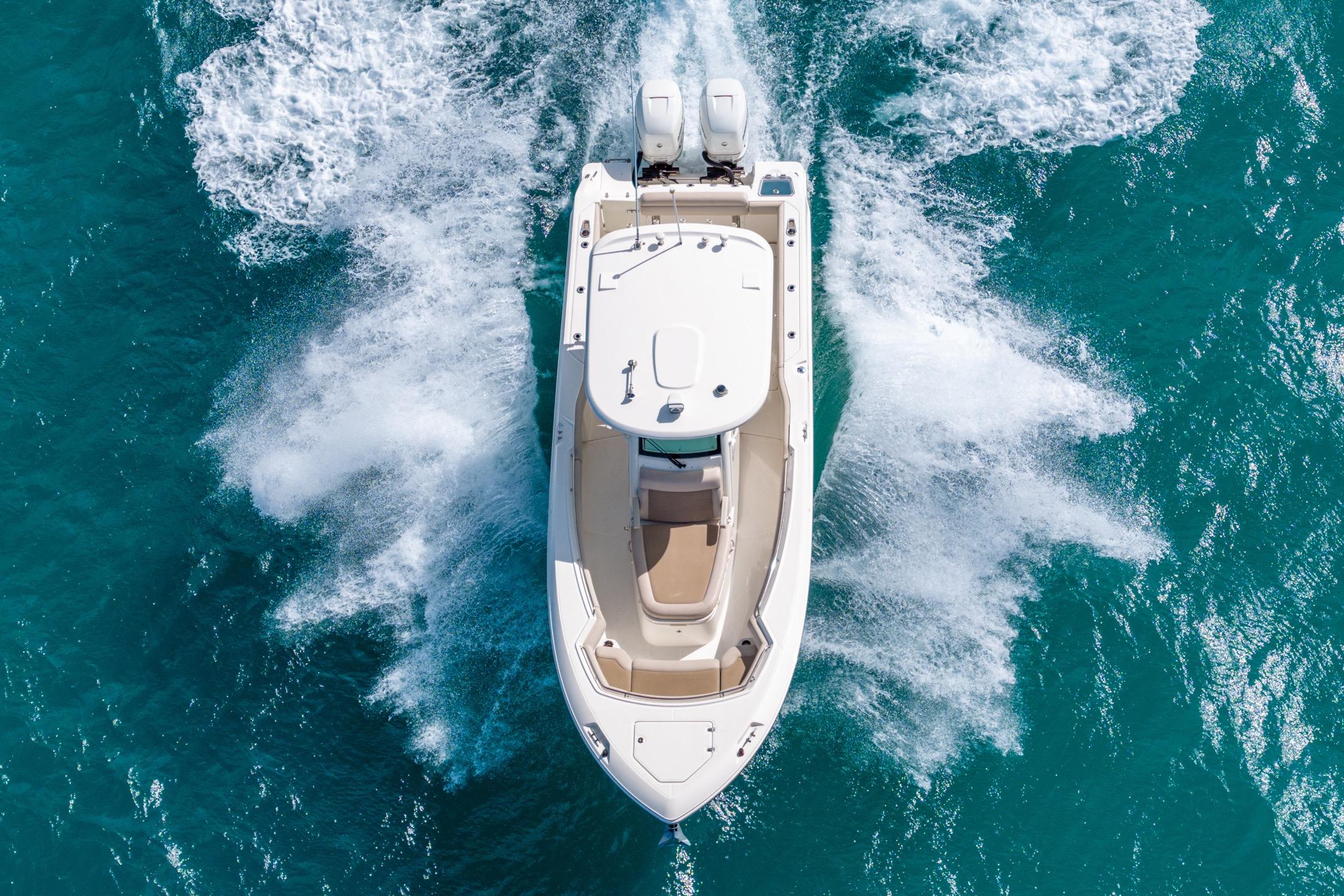 Aerial view of 2016 Boston Whaler 280 Outrage cruising on turquoise water.