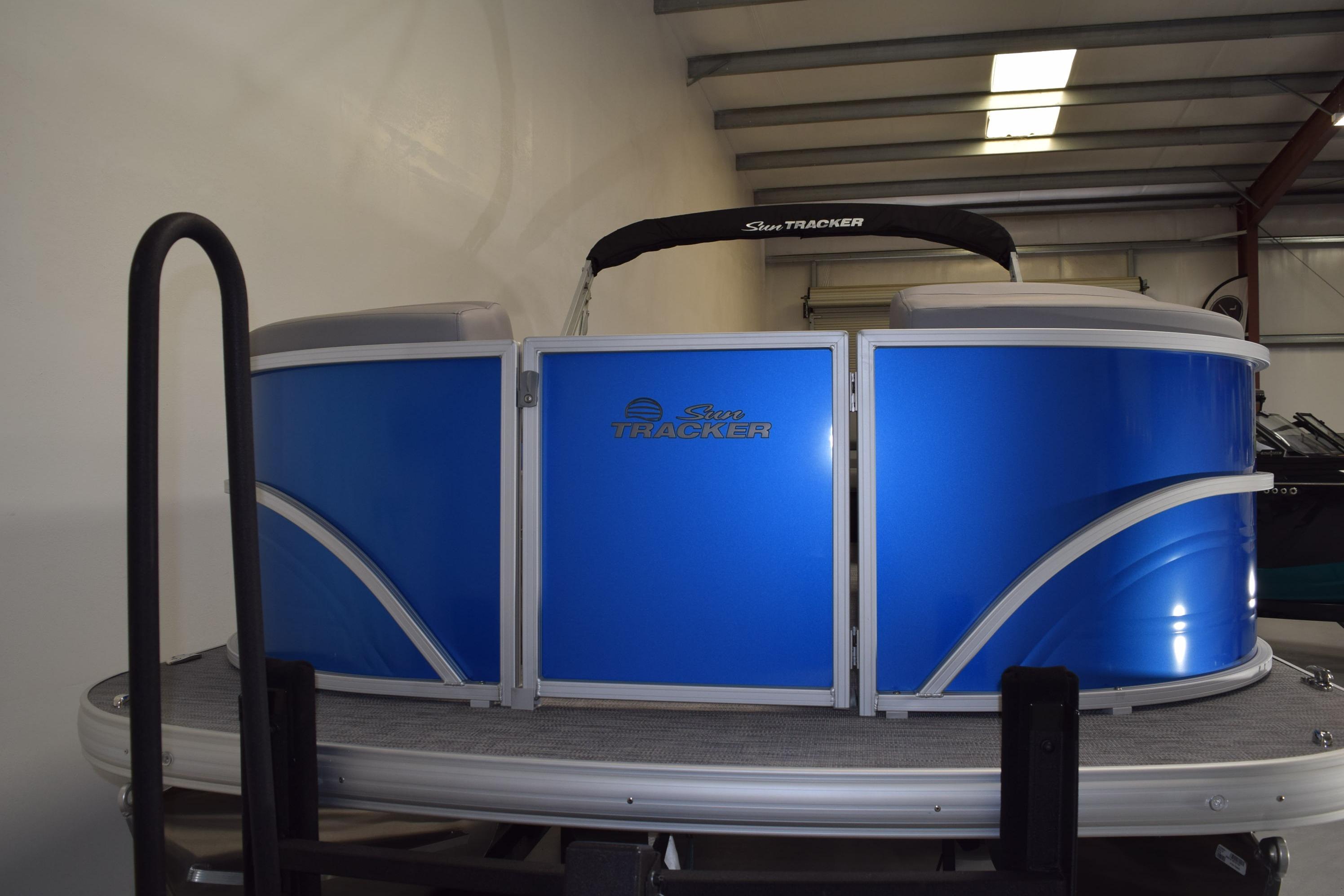 2026 Sun Tracker Party Barge 20 DLX pontoon boat in a showroom.