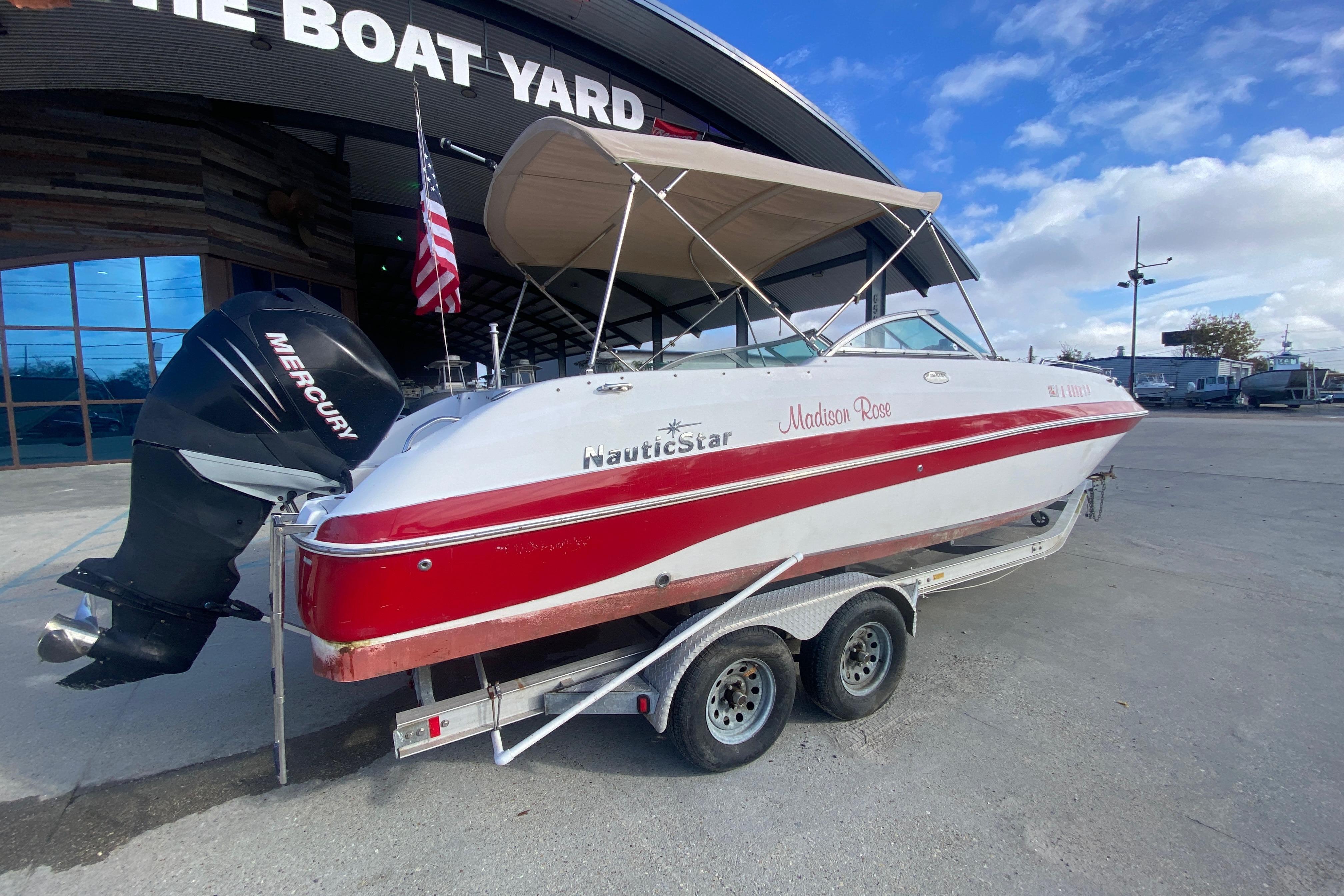 2007 NauticStar 230DC Sport Deck boat on trailer, with Mercury outboard motor.