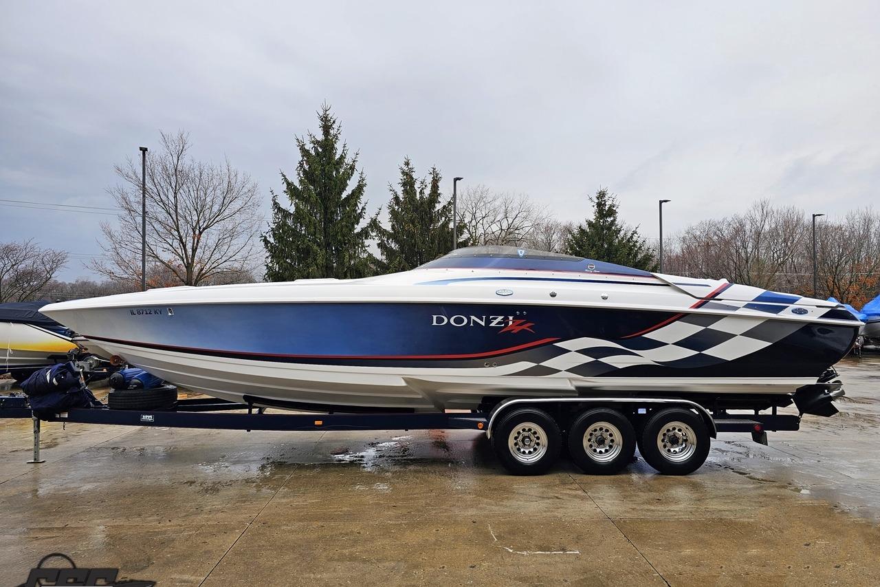 2000 Donzi 33 ZX speedboat on trailer, featuring sleek design and checkered graphics.