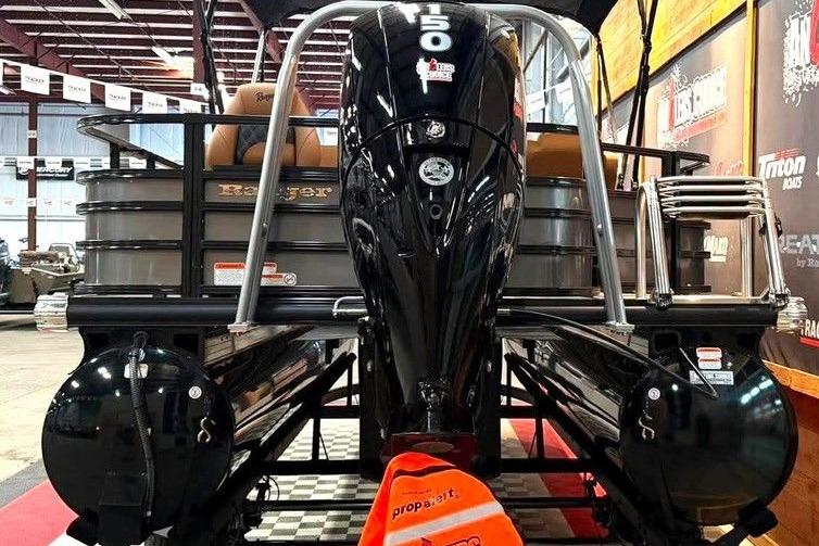 2026 Ranger 220F boat with powerful 150 HP engine displayed indoors.
