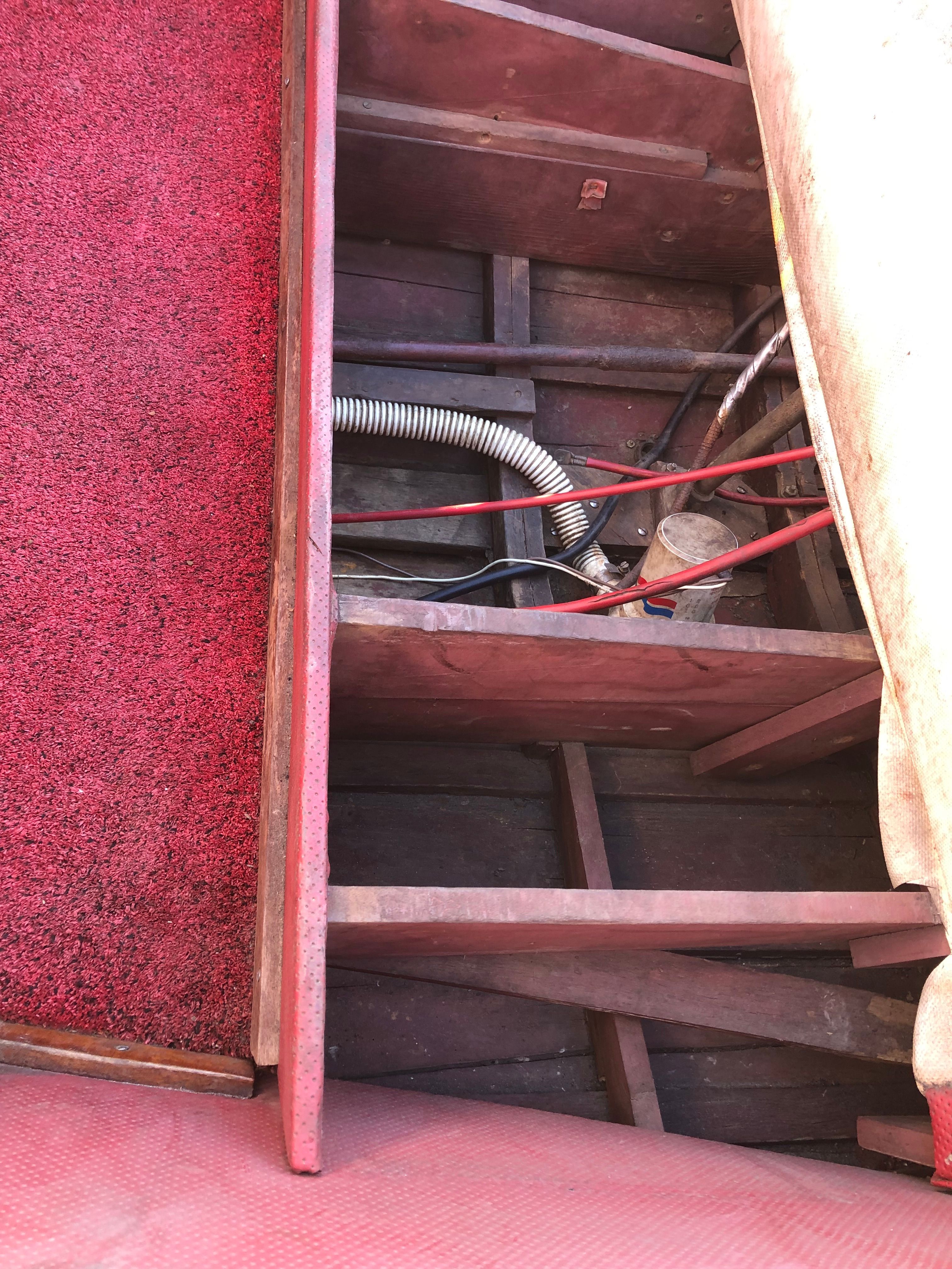 Interior view of a 1960 Century Resorter with red carpet and visible wiring.