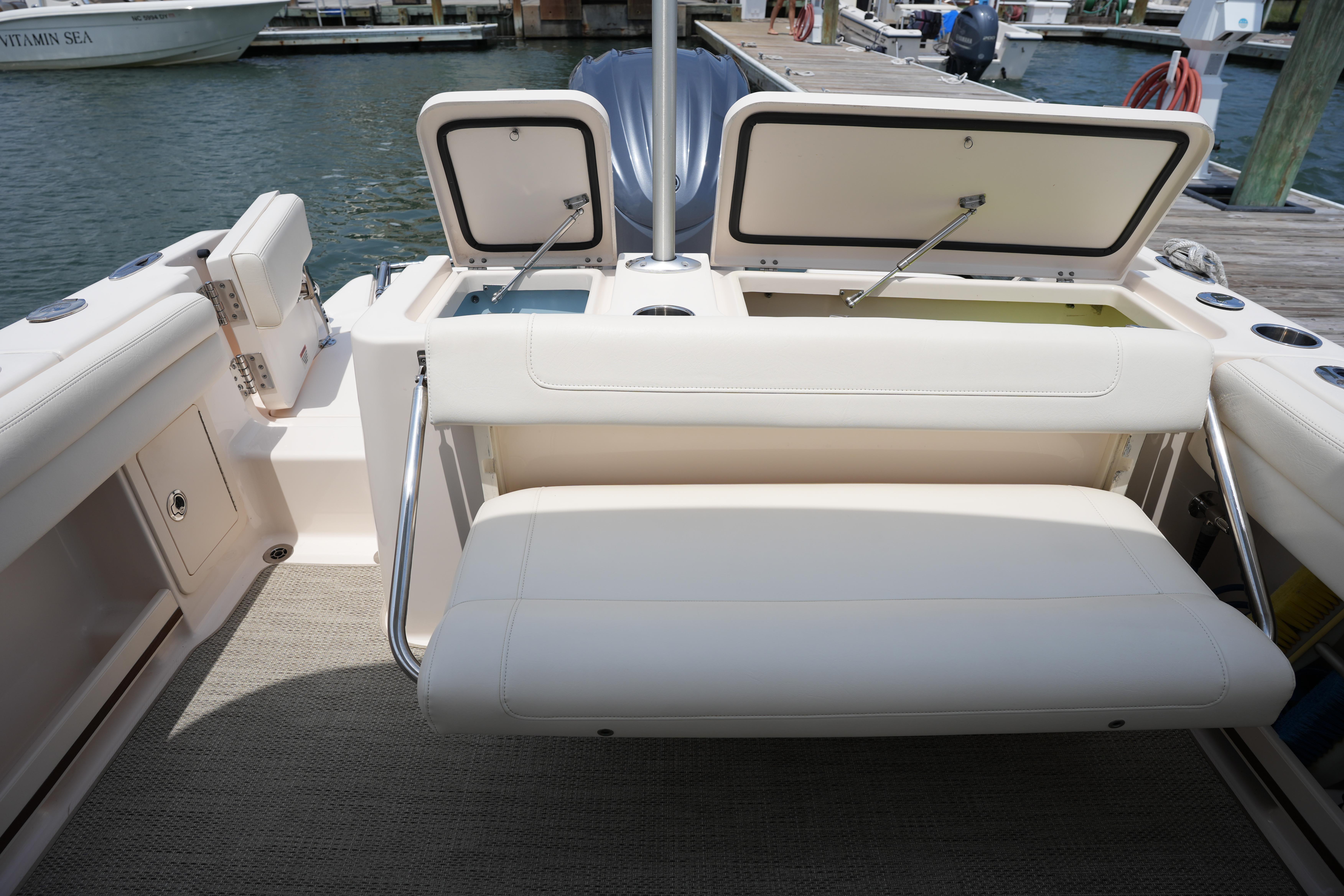 2021 Grady-White Freedom 235 boat interior with open storage compartments at dock.