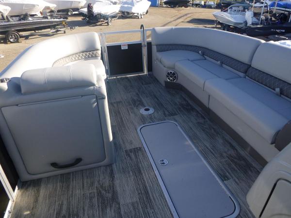 2024 Ranger Reata 223C boat interior with gray seating and wood-style flooring.