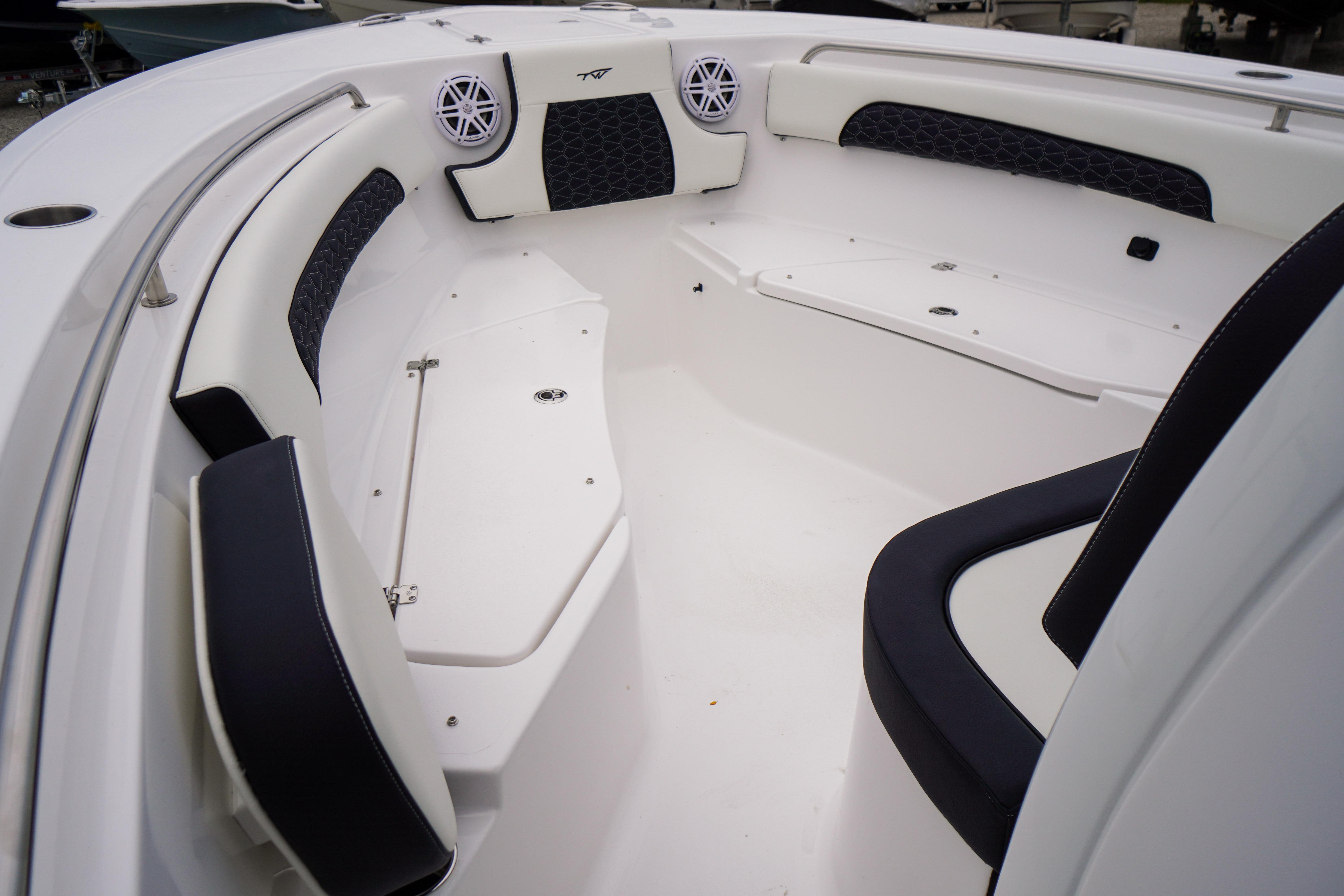 2026 Tidewater 232 SS boat interior with cushioned seating and speakers.
