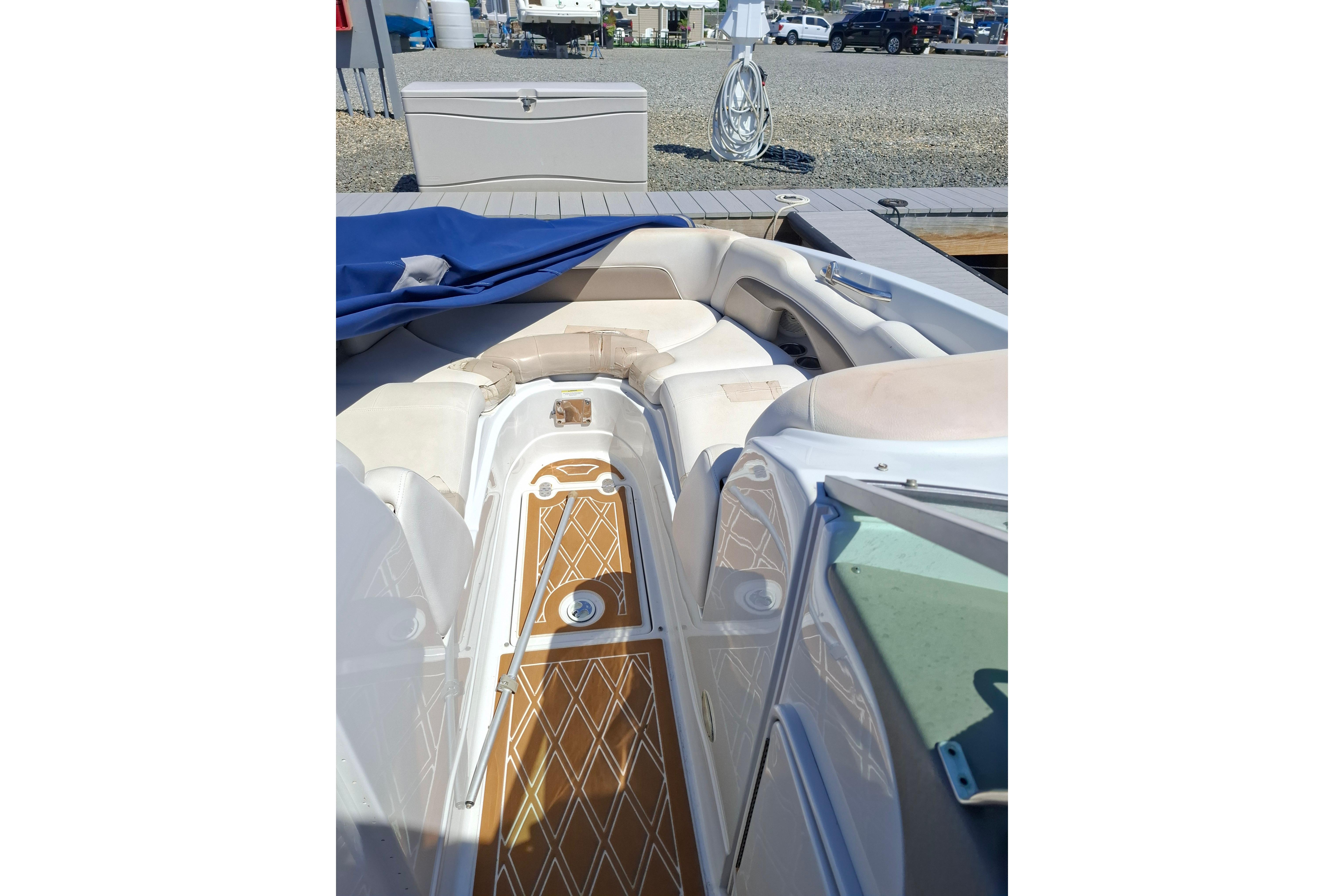2013 Crownline Eclipse E6 boat interior with cushioned seating and wooden flooring.
