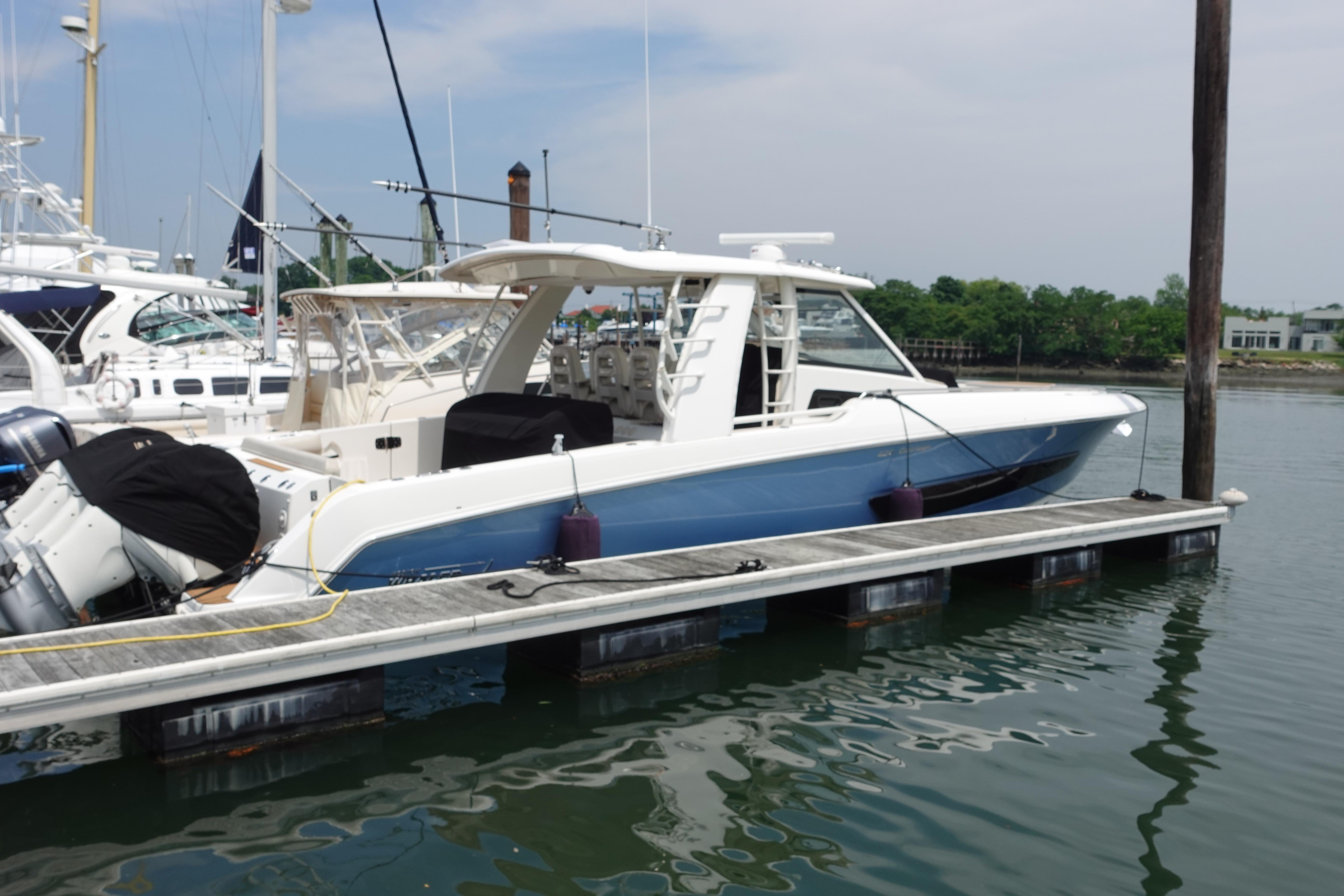 2020 Boston Whaler 420 Outrage docked at marina, showcasing sleek design and modern features.