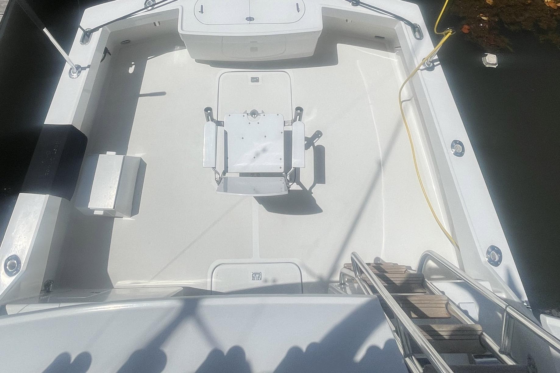 1968 Hatteras 34 Sport Fisherman boat deck with fishing chair and equipment.