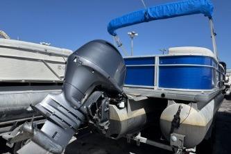 2021 Godfrey Sweetwater 2286 C pontoon boat with blue canopy and outboard motor.