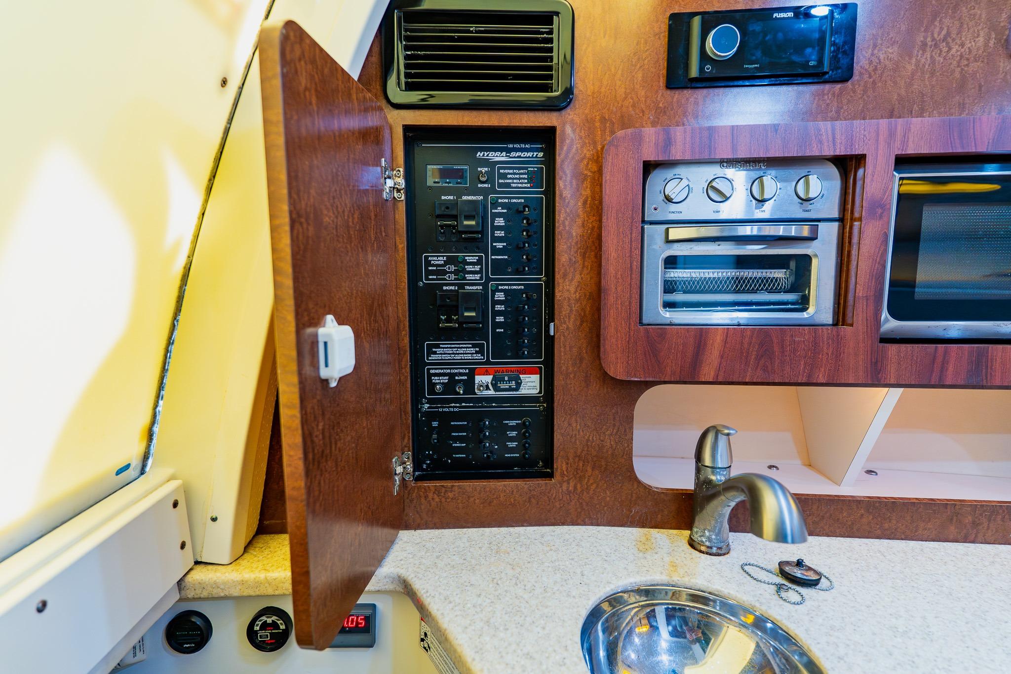 2008 Hydra-Sports Vector 3500 VX interior with control panel, oven, and sink.