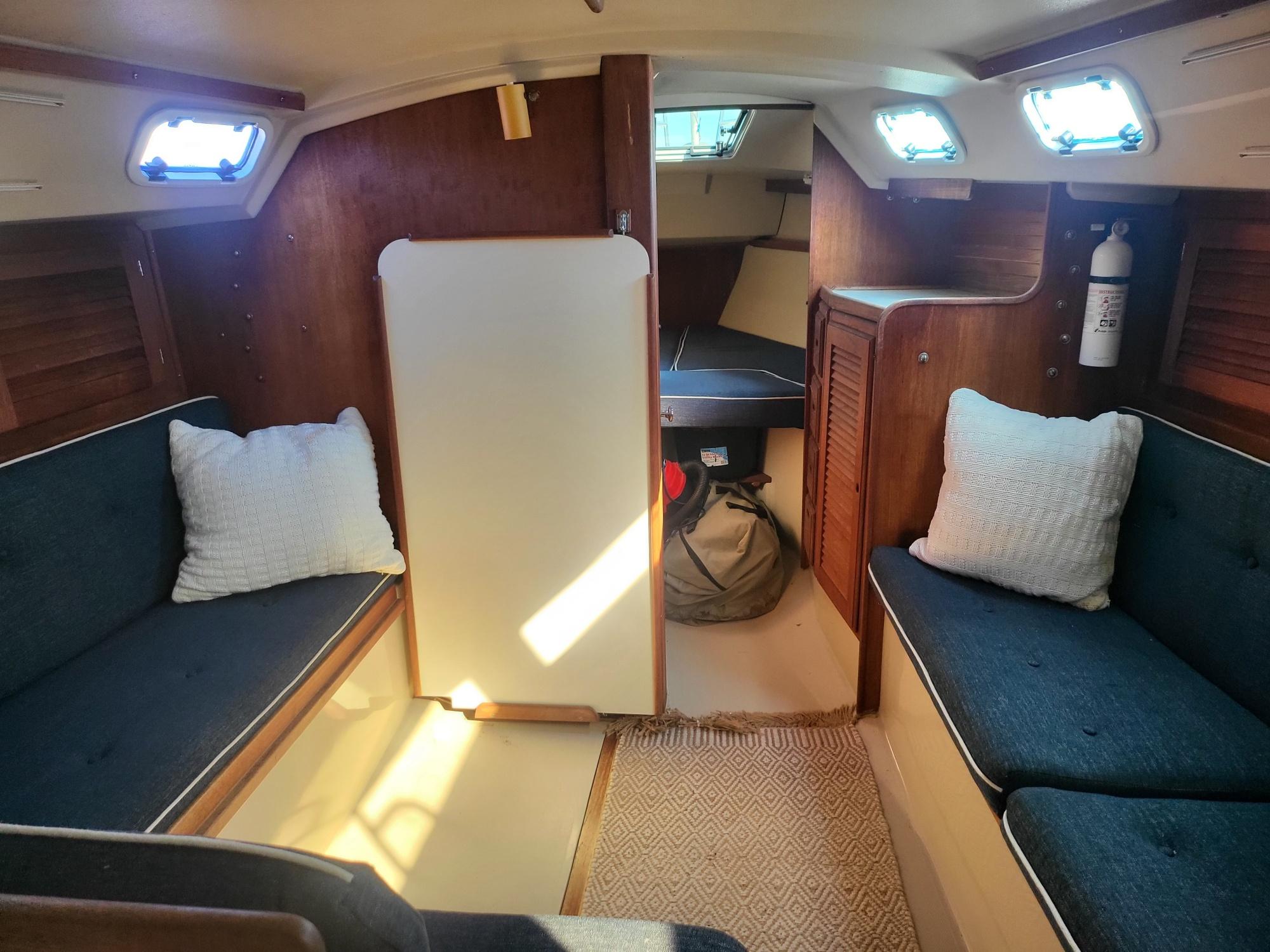 Interior of a 1988 Catalina 30 yacht with cozy seating areas.
