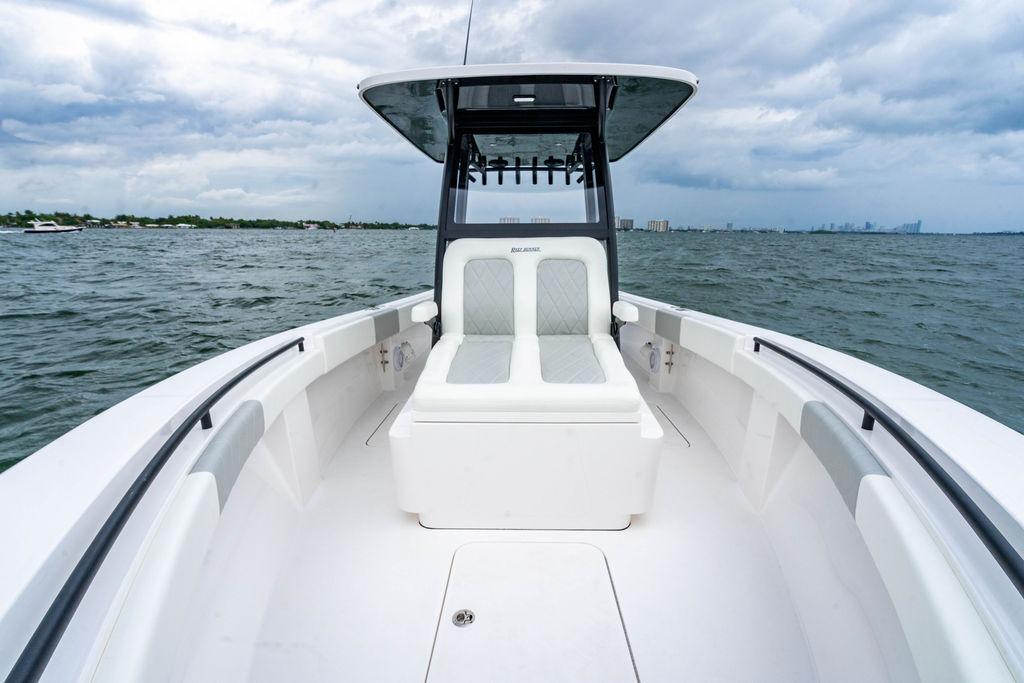 2027 Reef Runner 280 boat on open water, featuring sleek seating and modern design.