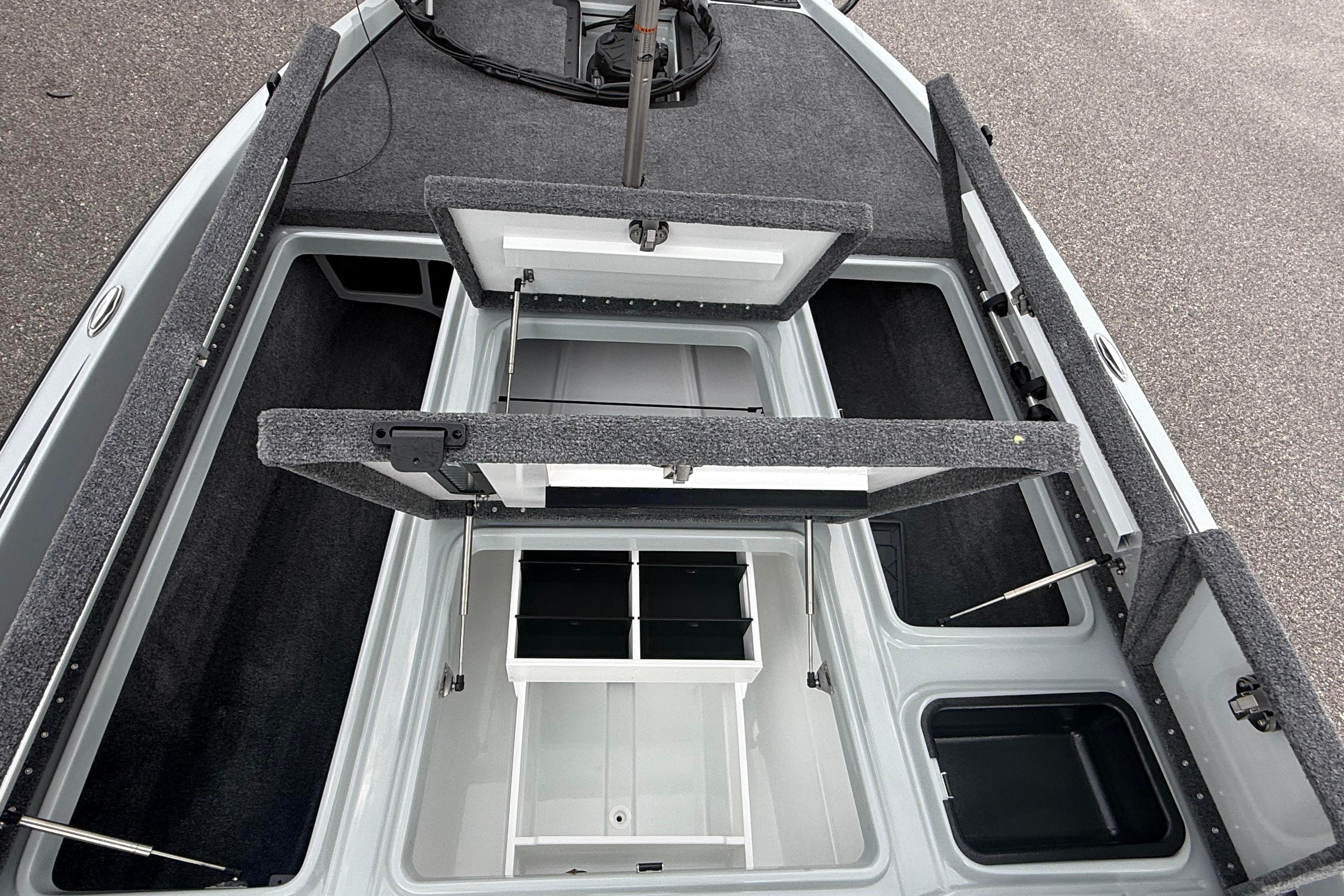Open storage compartments on a 2027 Phoenix 921 Elite X II boat deck.