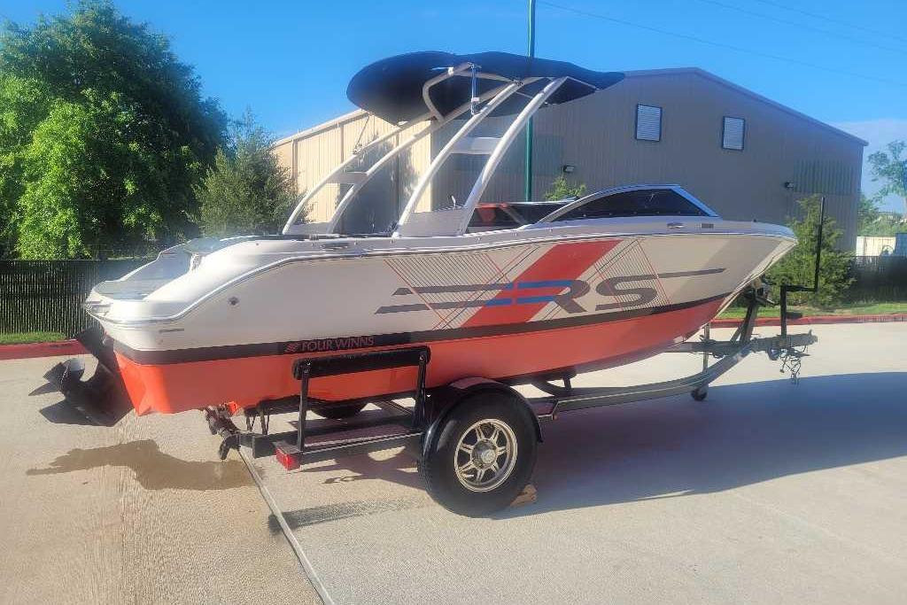 2016 Four Winns H200RS boat on trailer, featuring sleek design and vibrant colors.
