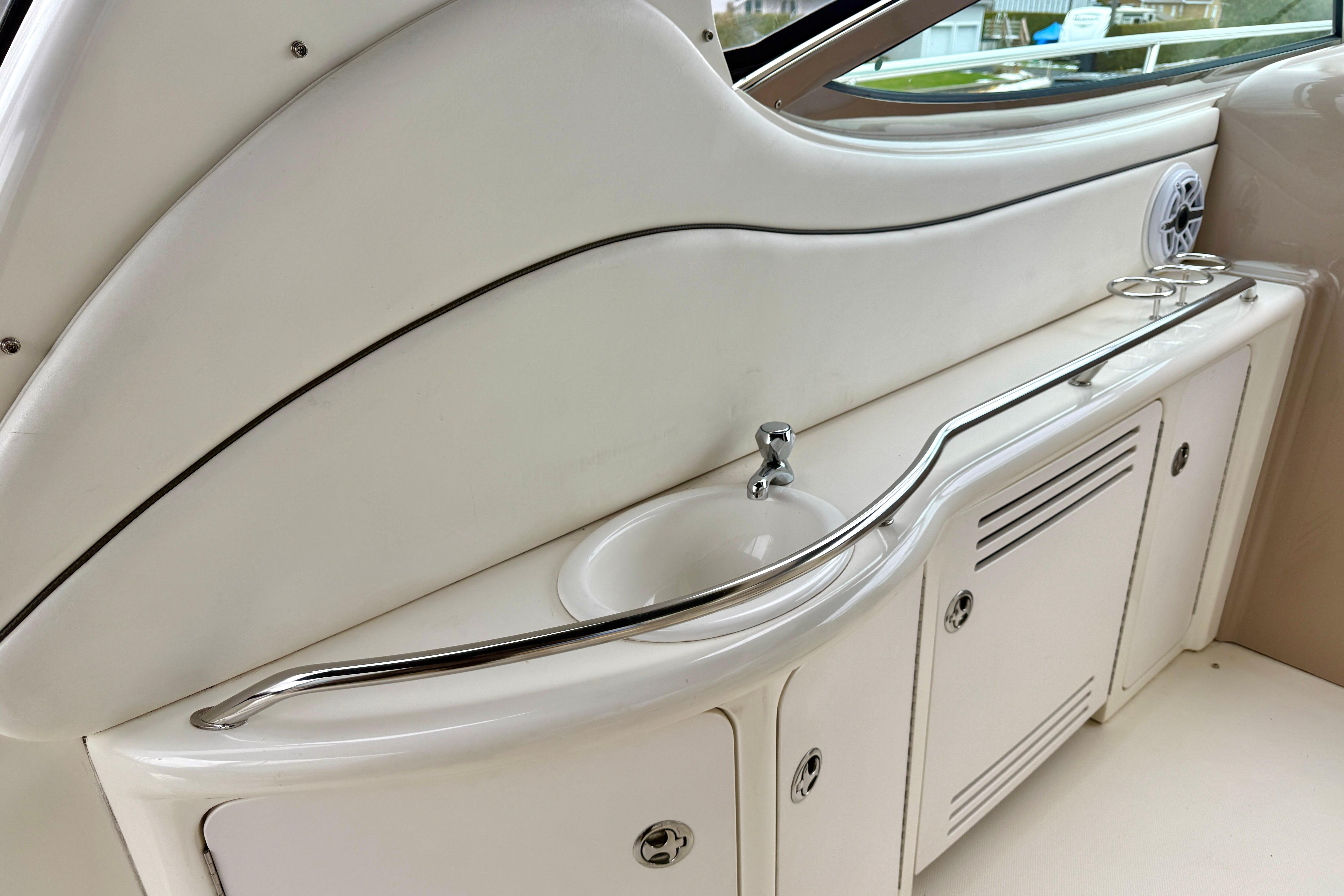 2004 Searay 360 Sundancer boat interior with sink and storage cabinets.