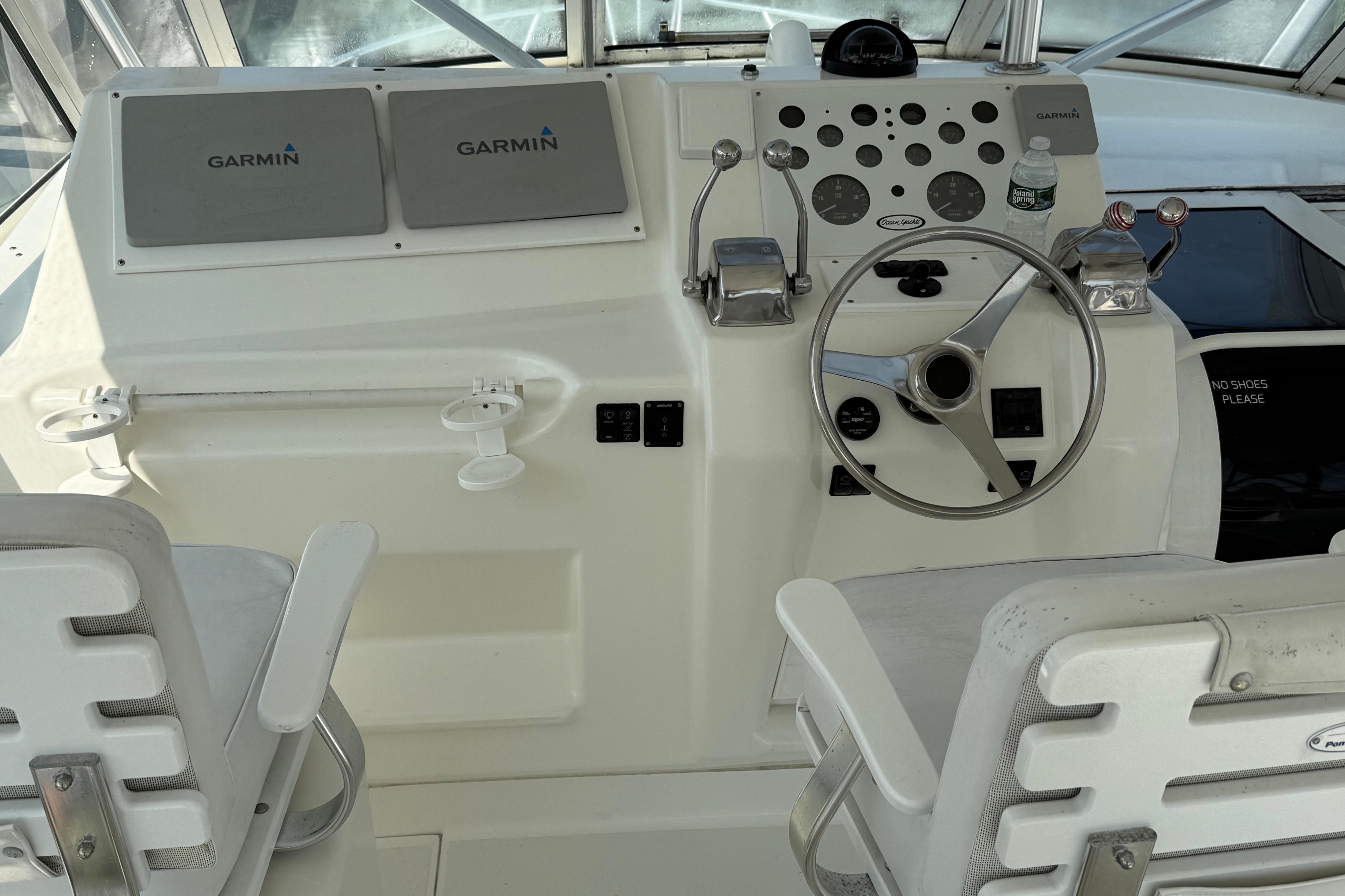 Cockpit of 1999 Ocean Yachts 40 Express with Garmin navigation system and steering wheel.