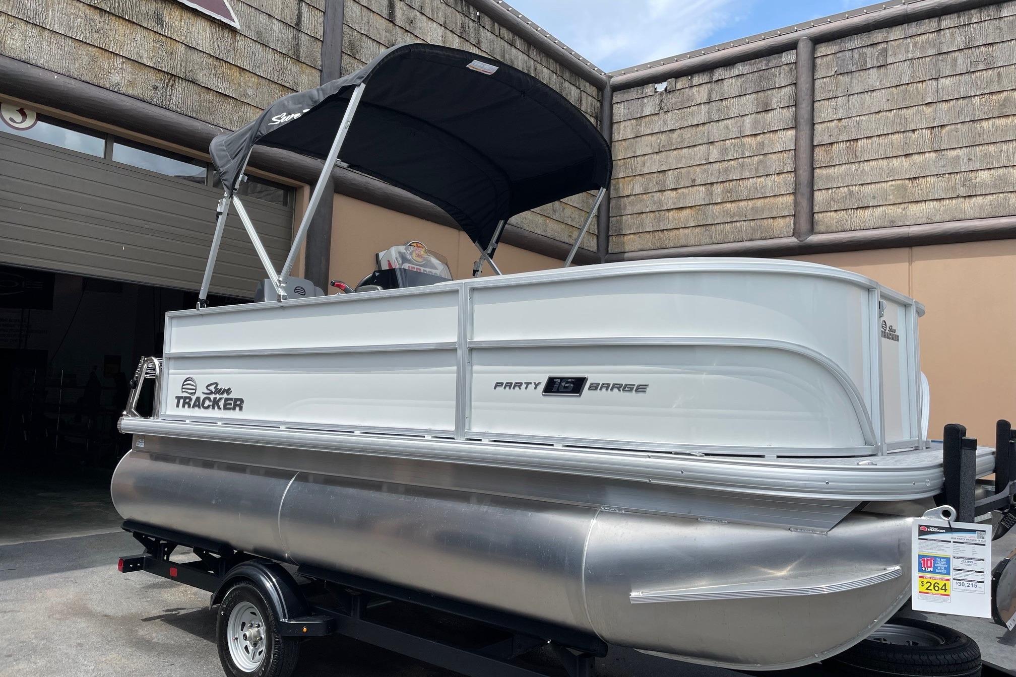 2026 Sun Tracker Party Barge 16 DLX pontoon boat on trailer, outdoor setting.