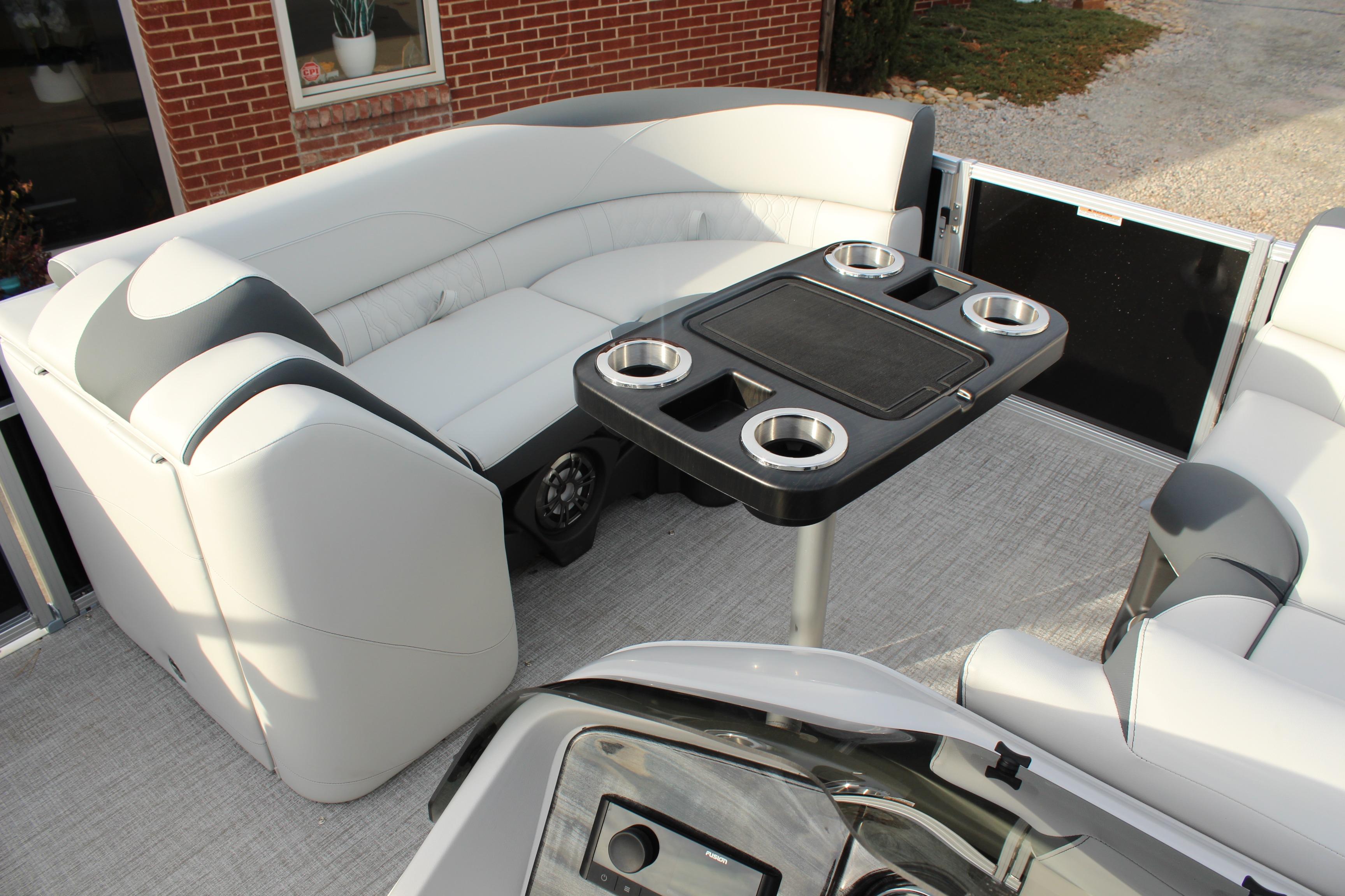Luxurious 2026 Tahoe Pontoon LTZ interior with plush seating and a central table.