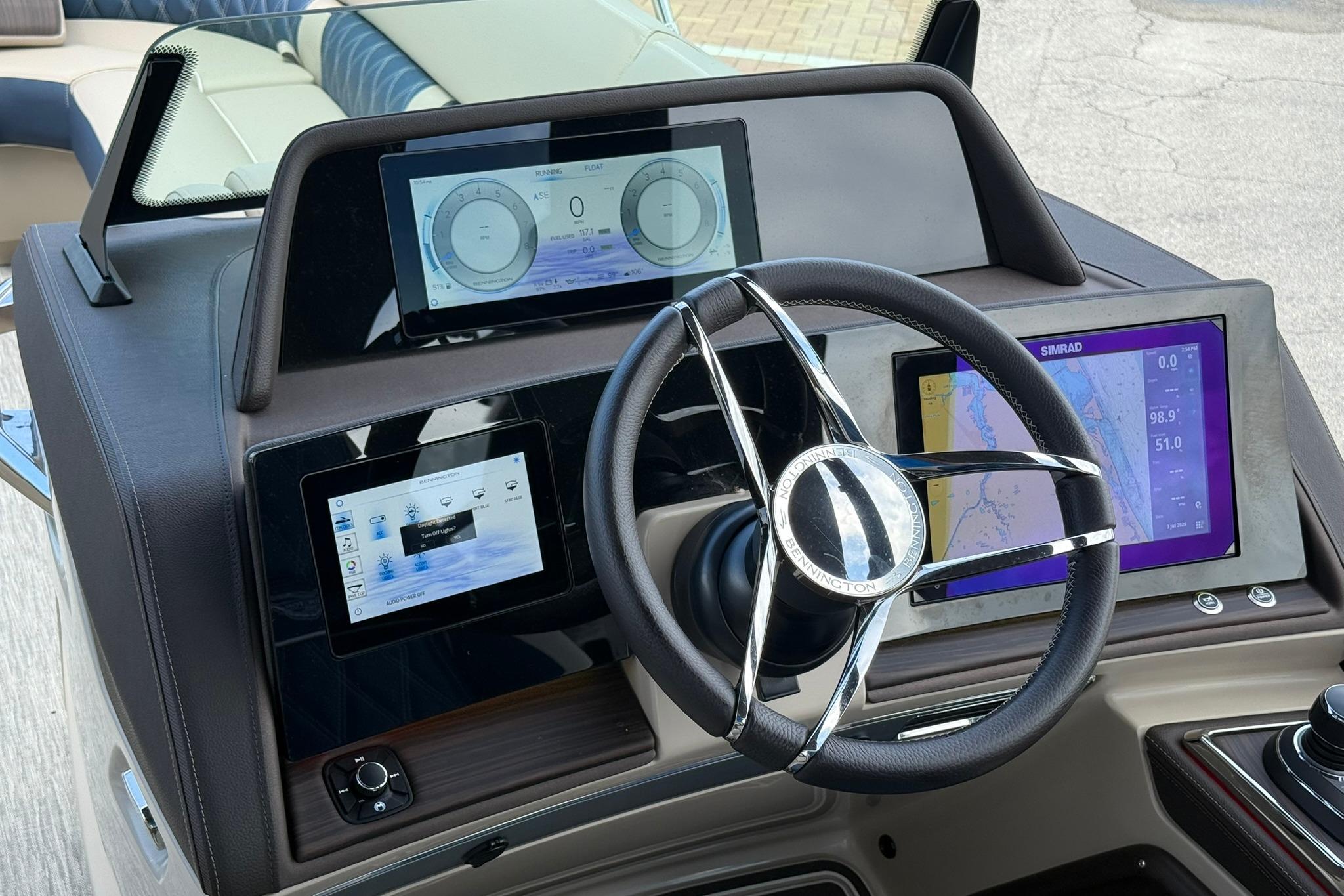 Helm of 2026 Bennington 27 QSBAT2 with advanced navigation displays and steering wheel.