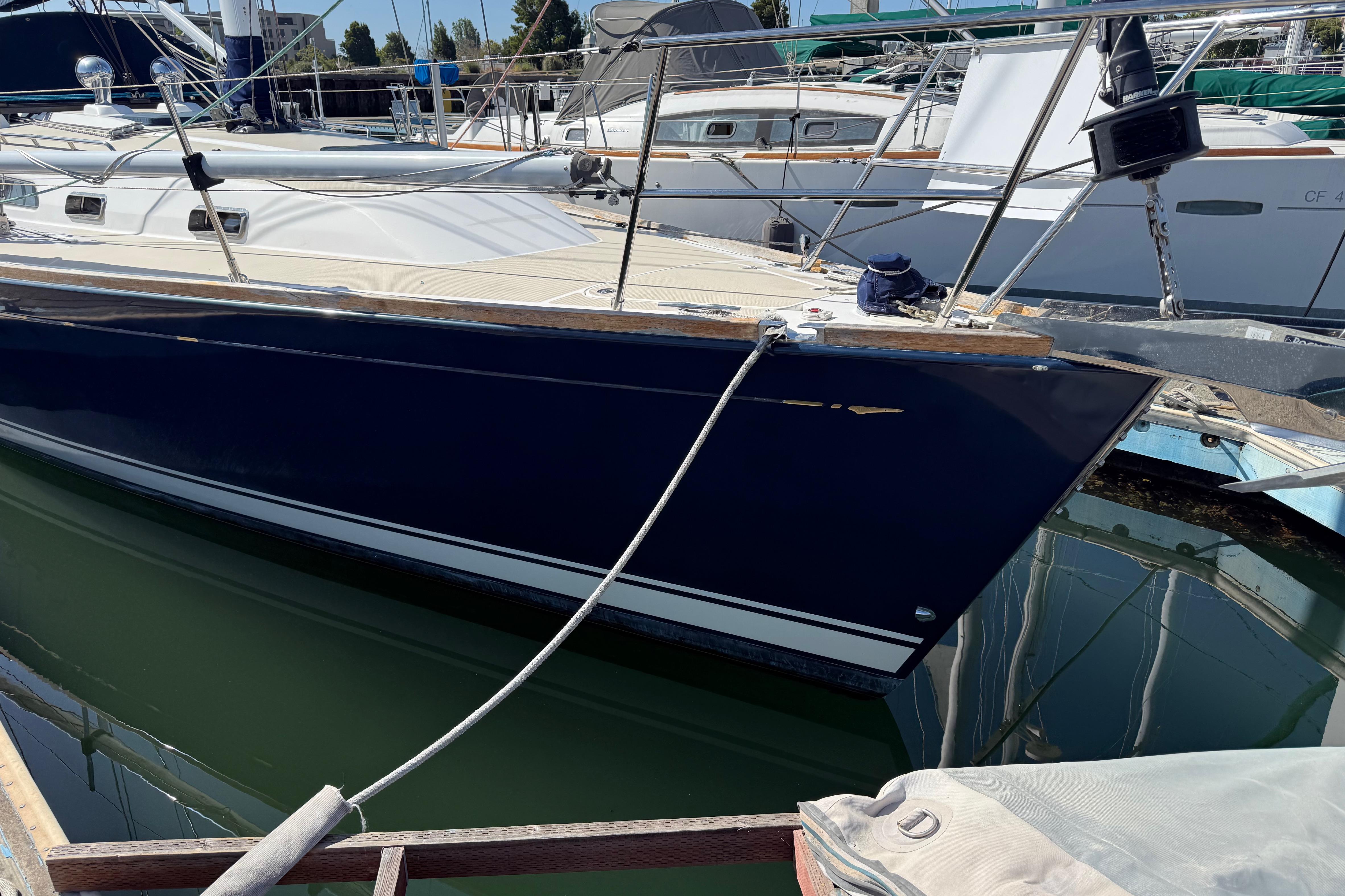 Sleek 2004 Sabre 386 sailboat docked in marina, showcasing elegant design and craftsmanship.