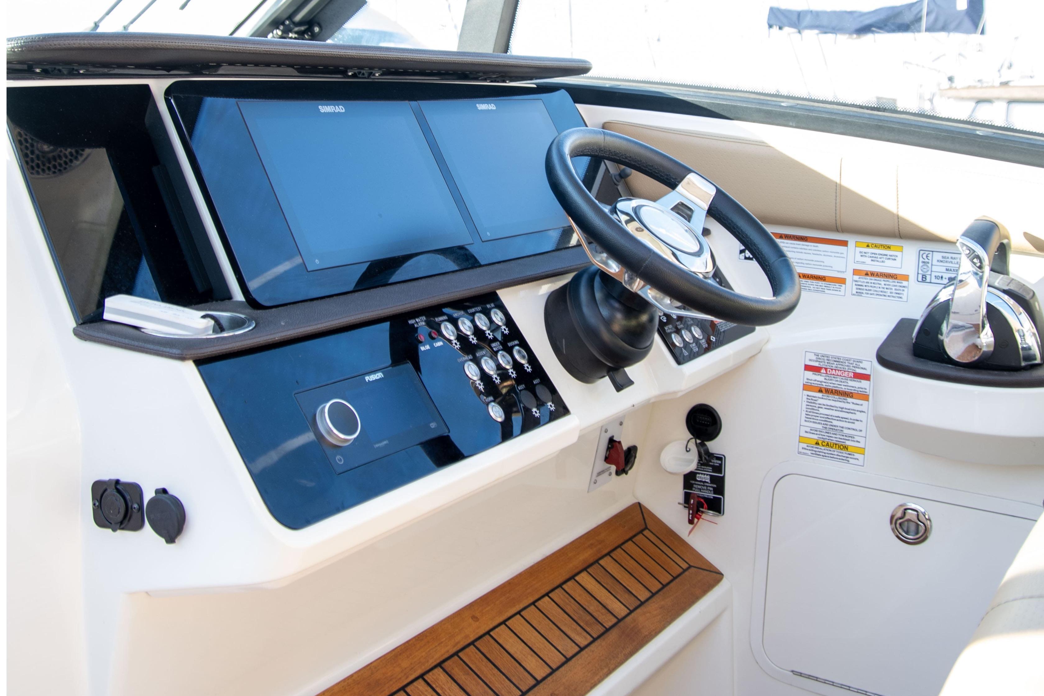 2022 Sea Ray Sundancer 320 helm with modern controls and dual display screens.