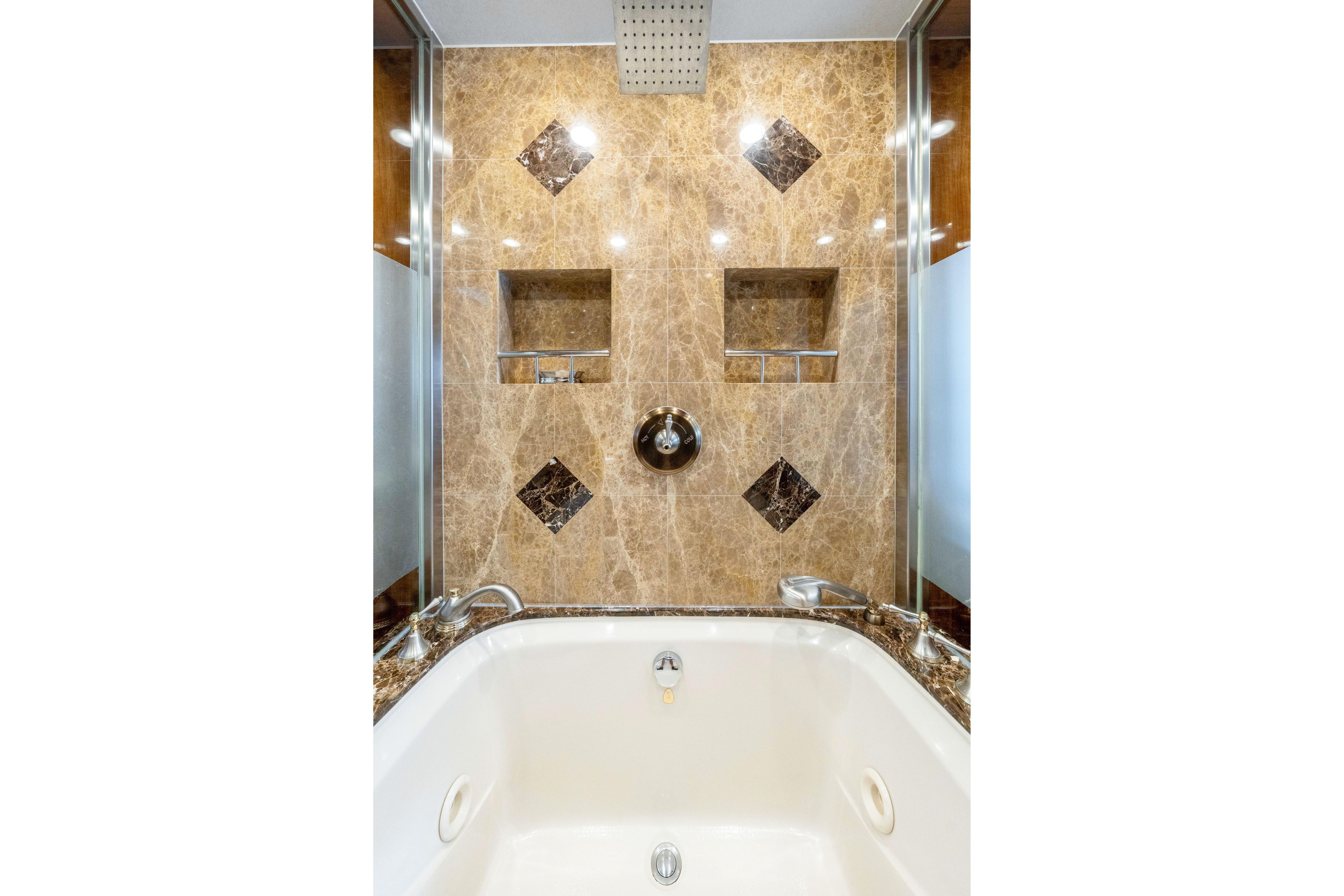 Luxurious marble bathroom in 2009 Hargrave Raised Pilothouse yacht, featuring elegant fixtures.