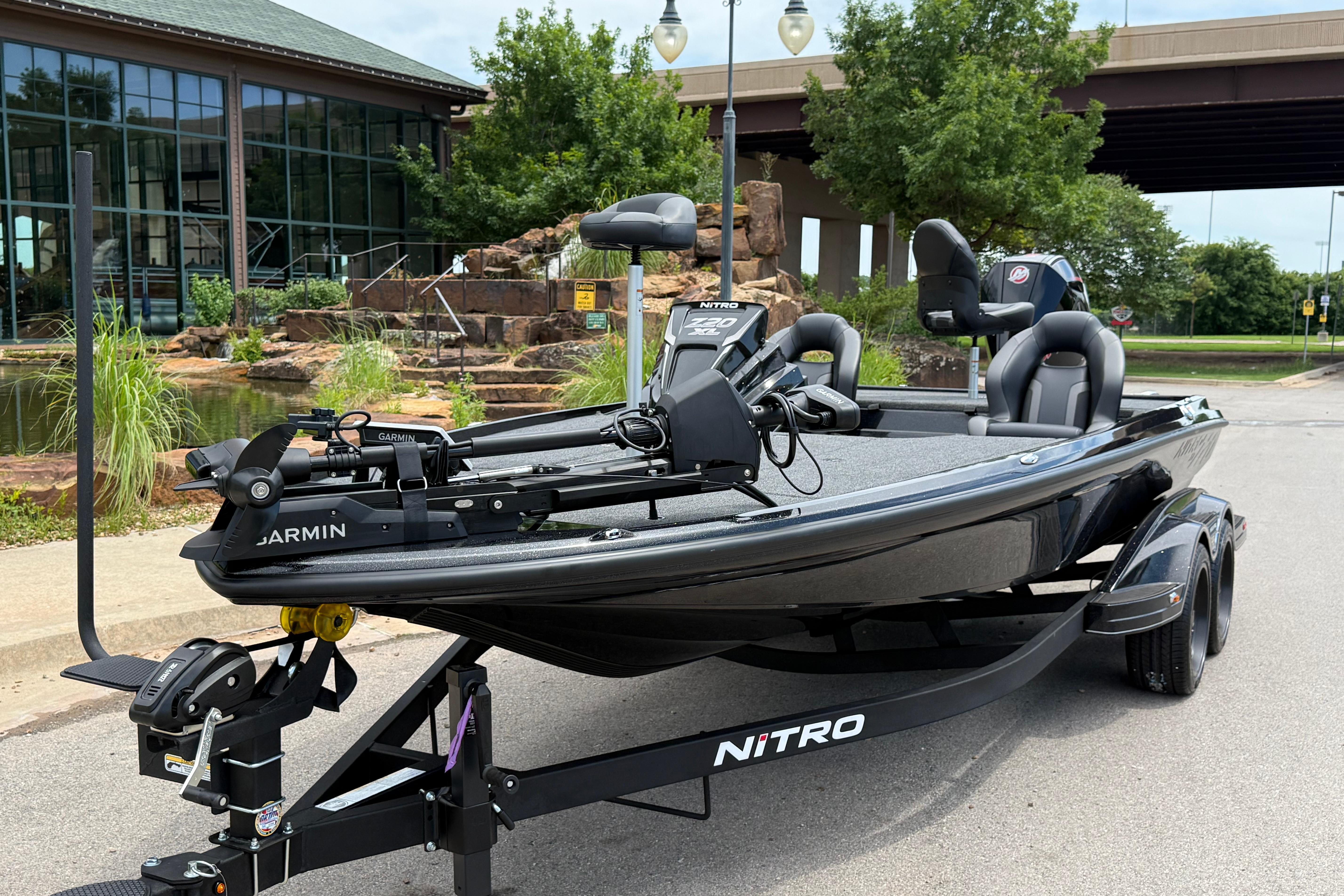 2026 Nitro Z20 XL Pro fishing boat parked outdoors near a pond.