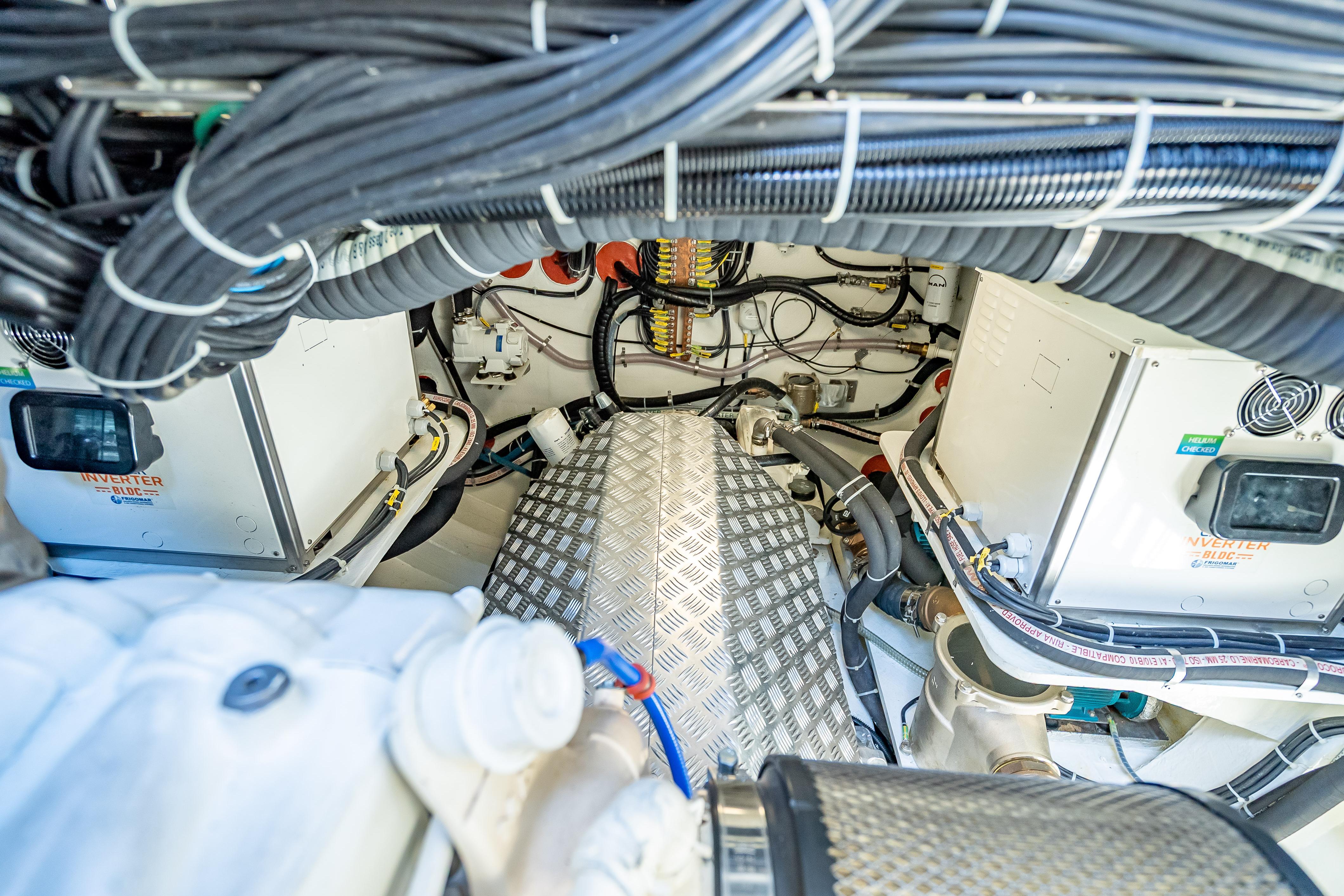 Engine room of 2026 Sunreef 60 Power yacht, showcasing wiring and machinery.