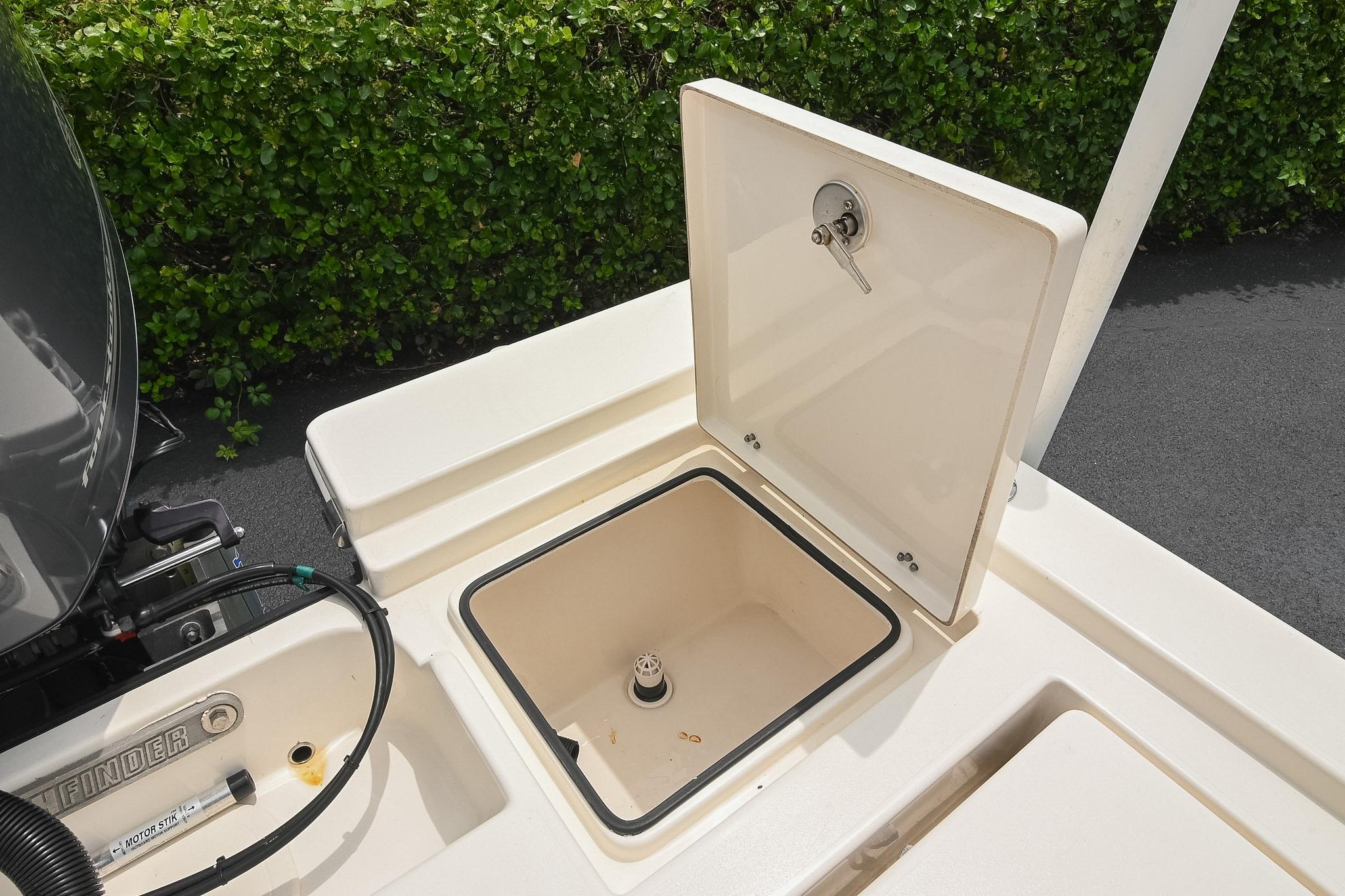 Open storage compartment on 2021 Pathfinder 2200 TRS boat, showcasing interior details.