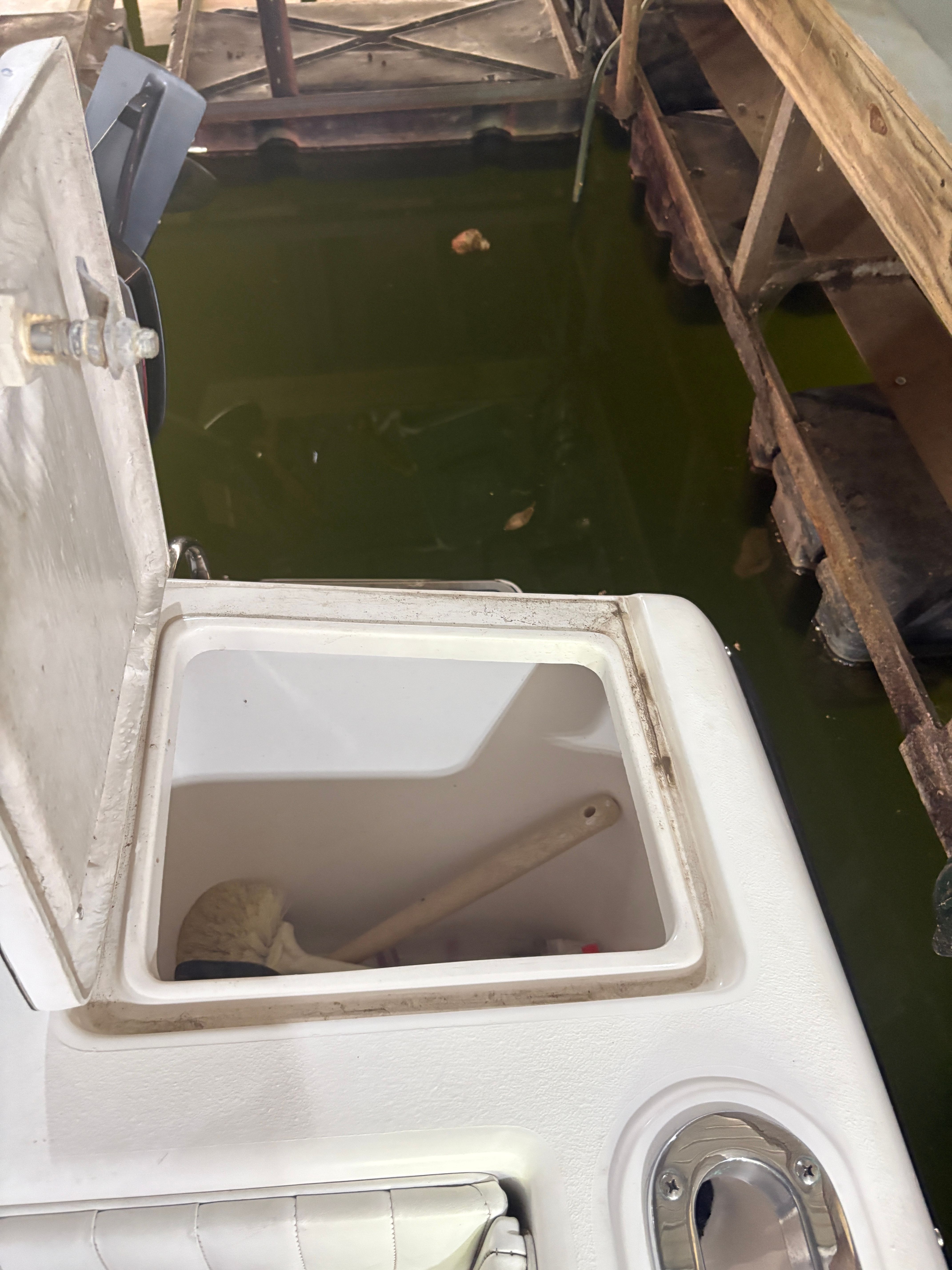 Intrepid 322 Cuddy Center Console 2002, open storage compartment at dock.