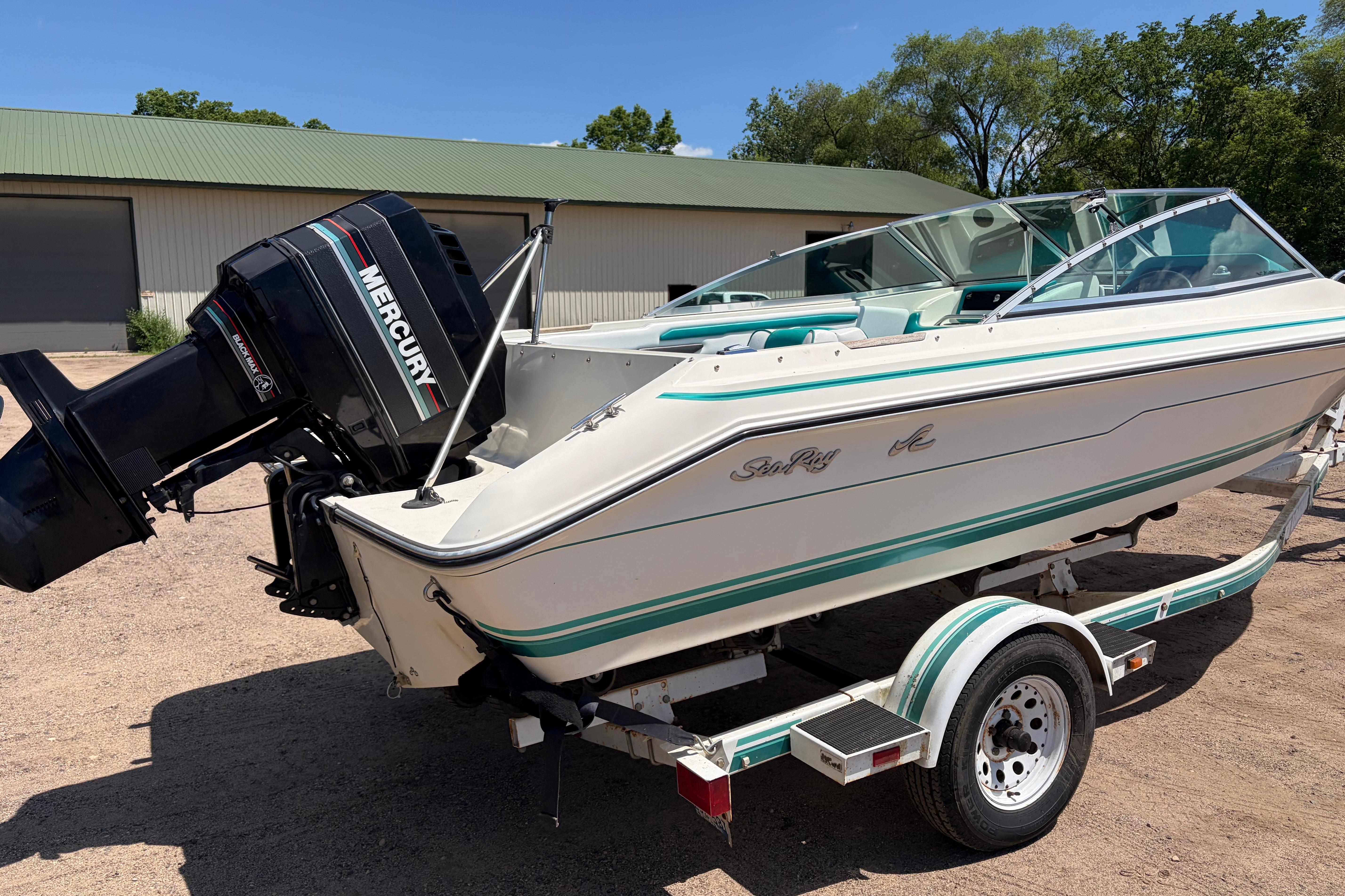 1990 Sea Ray 180 Bow Rider boat with Mercury outboard motor on trailer.