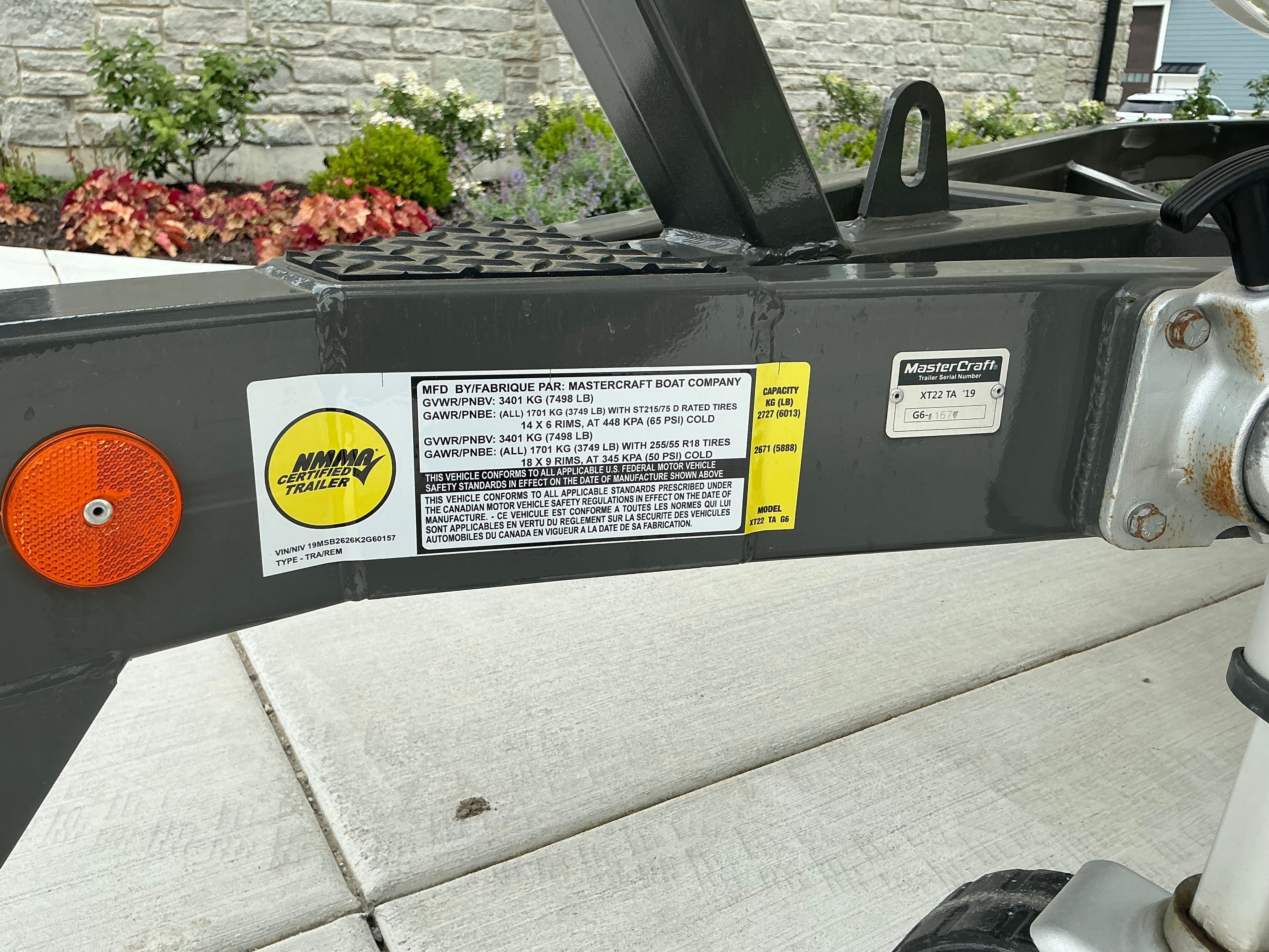 Close-up of a boat trailer with manufacturer label and safety information.