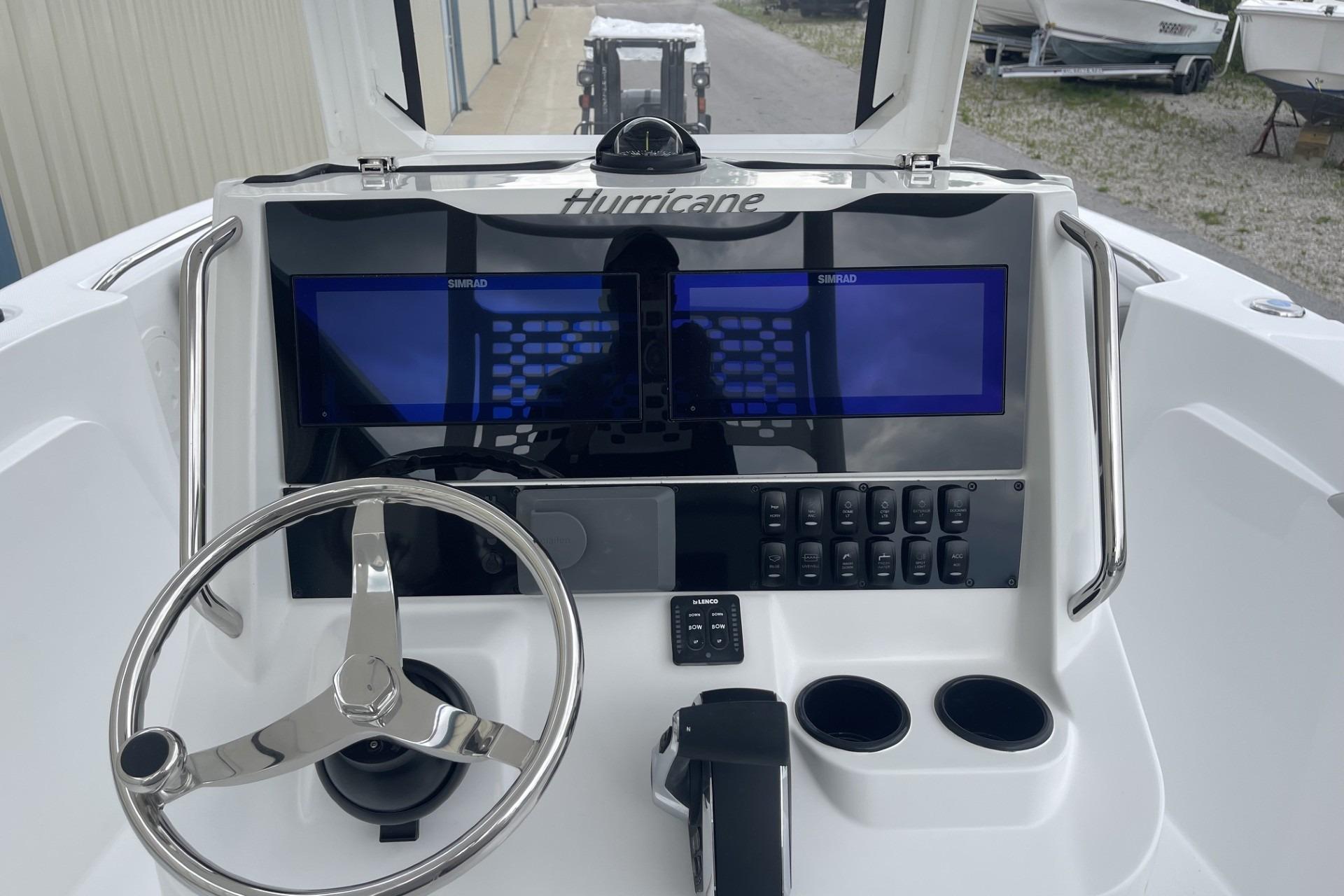 2026 Hurricane Center Console 24 OB dashboard with steering wheel and dual Simrad displays.