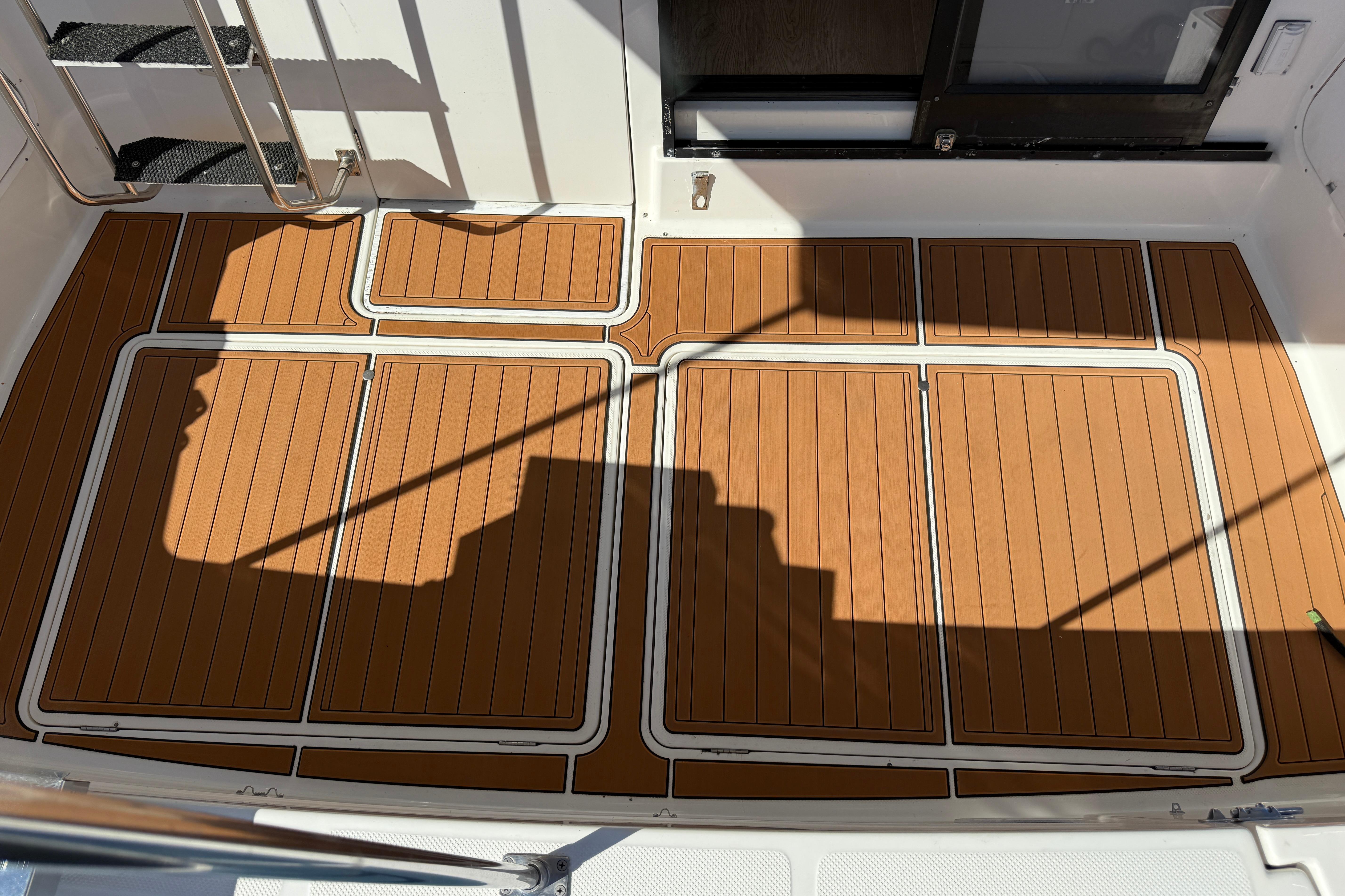 1997 Bayliner 3988 Command Bridge Motoryacht deck with teak-style flooring and stainless steel railings.