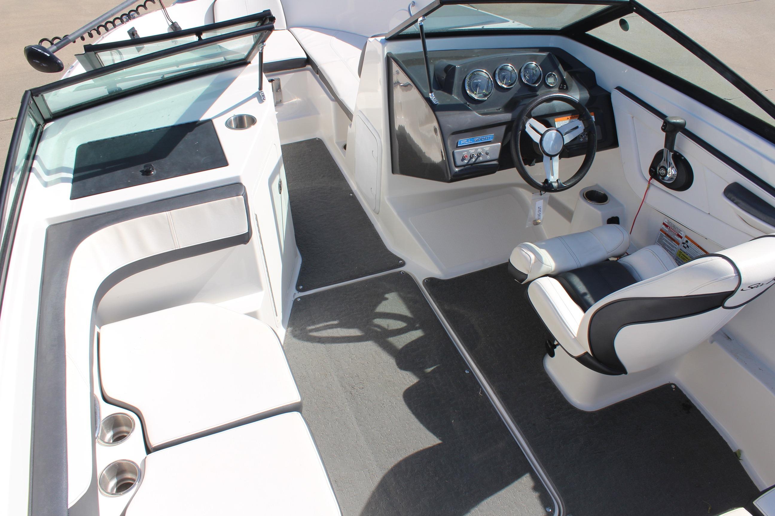 Interior view of 2015 Sea Ray 19 SPX OB boat, featuring steering wheel and seating.