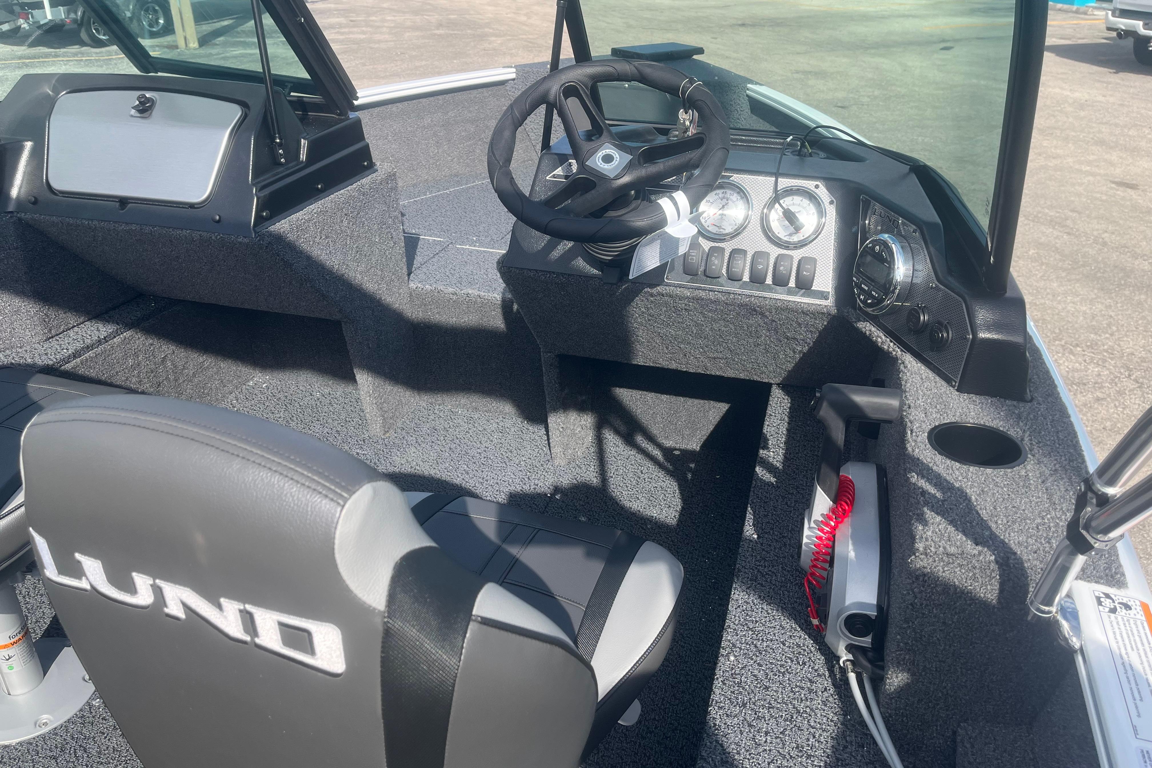2026 Lund 1650 Rebel XL Sport boat interior with steering wheel and dashboard controls.