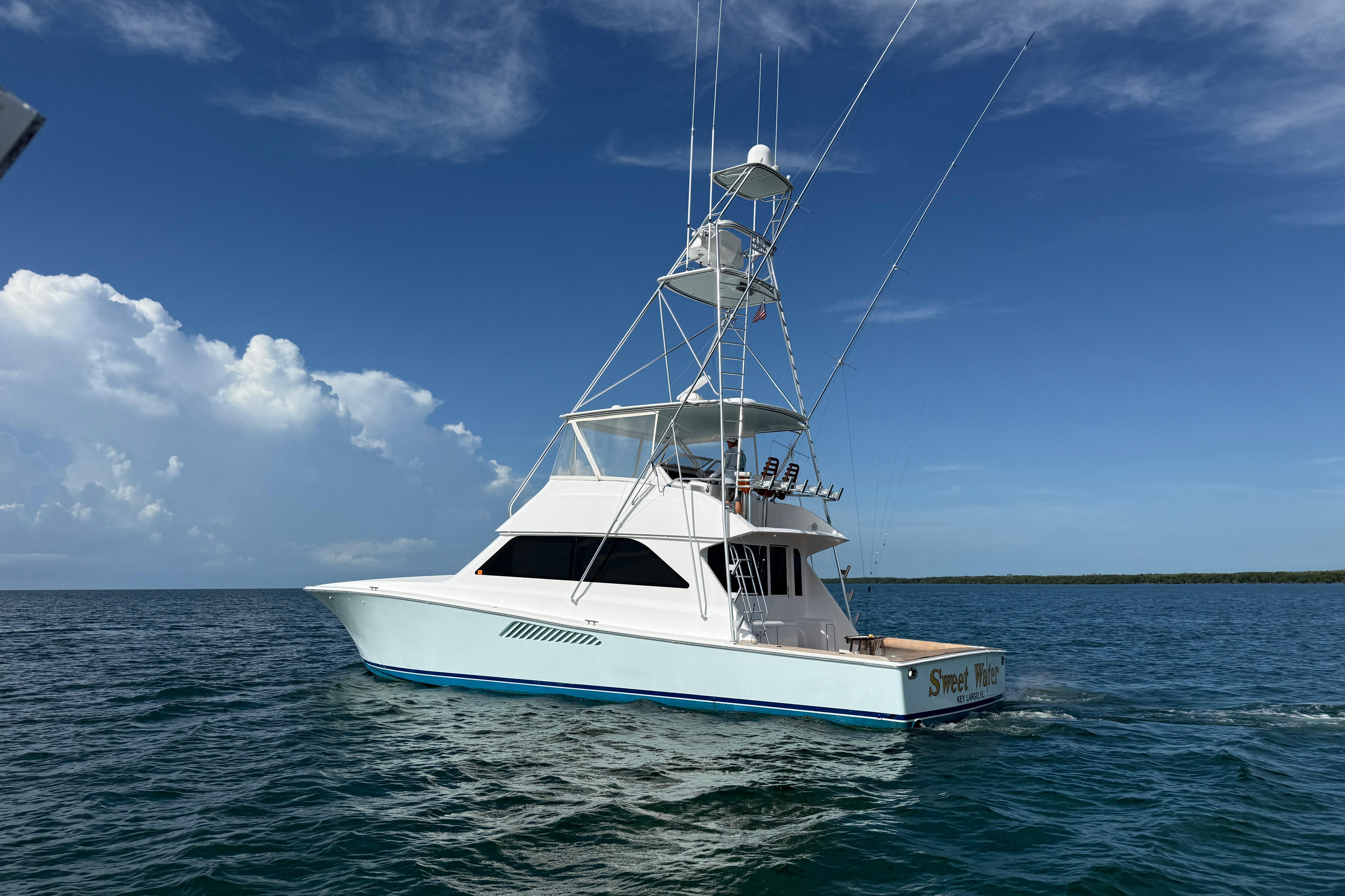 2000 Viking 55 Convertible yacht cruising on open water under clear skies.