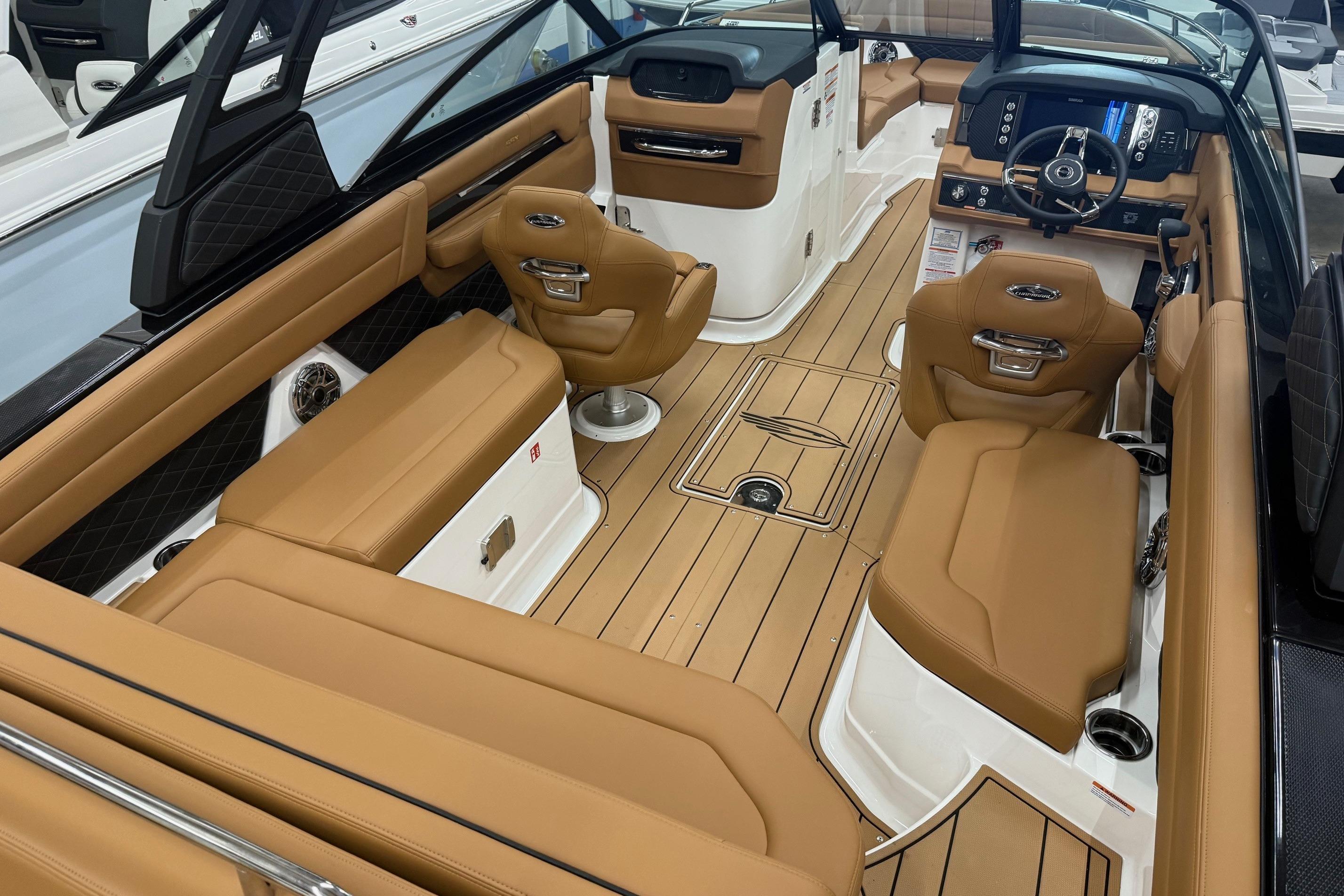 Luxurious interior of 2026 Chaparral SSX 6 boat with tan leather seating and modern dashboard.