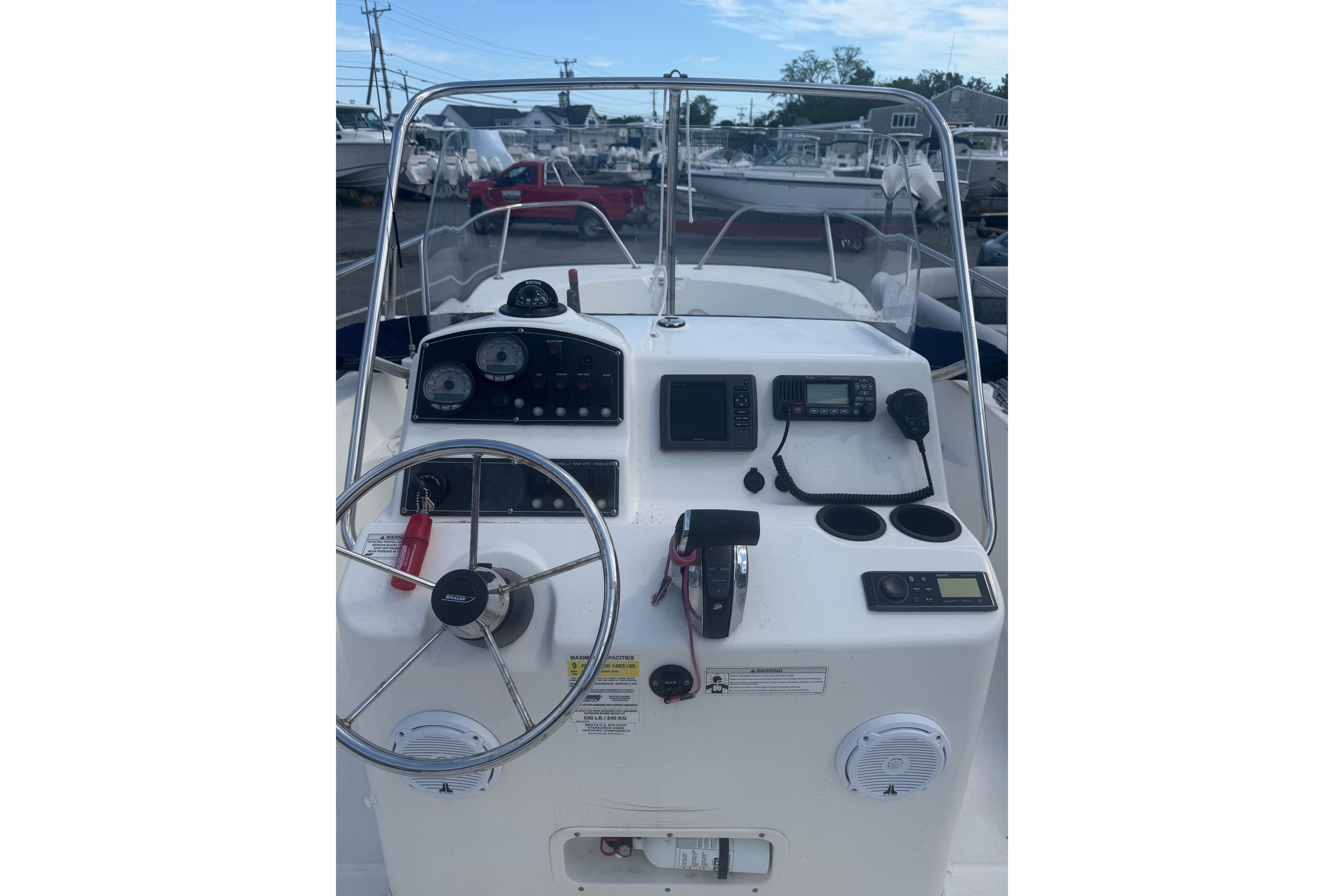 2015 Boston Whaler 210 Montauk boat console with steering wheel and navigation instruments.