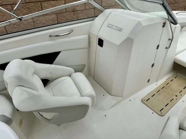 2006 Larson LXi 248 boat interior with white seating and dashboard.