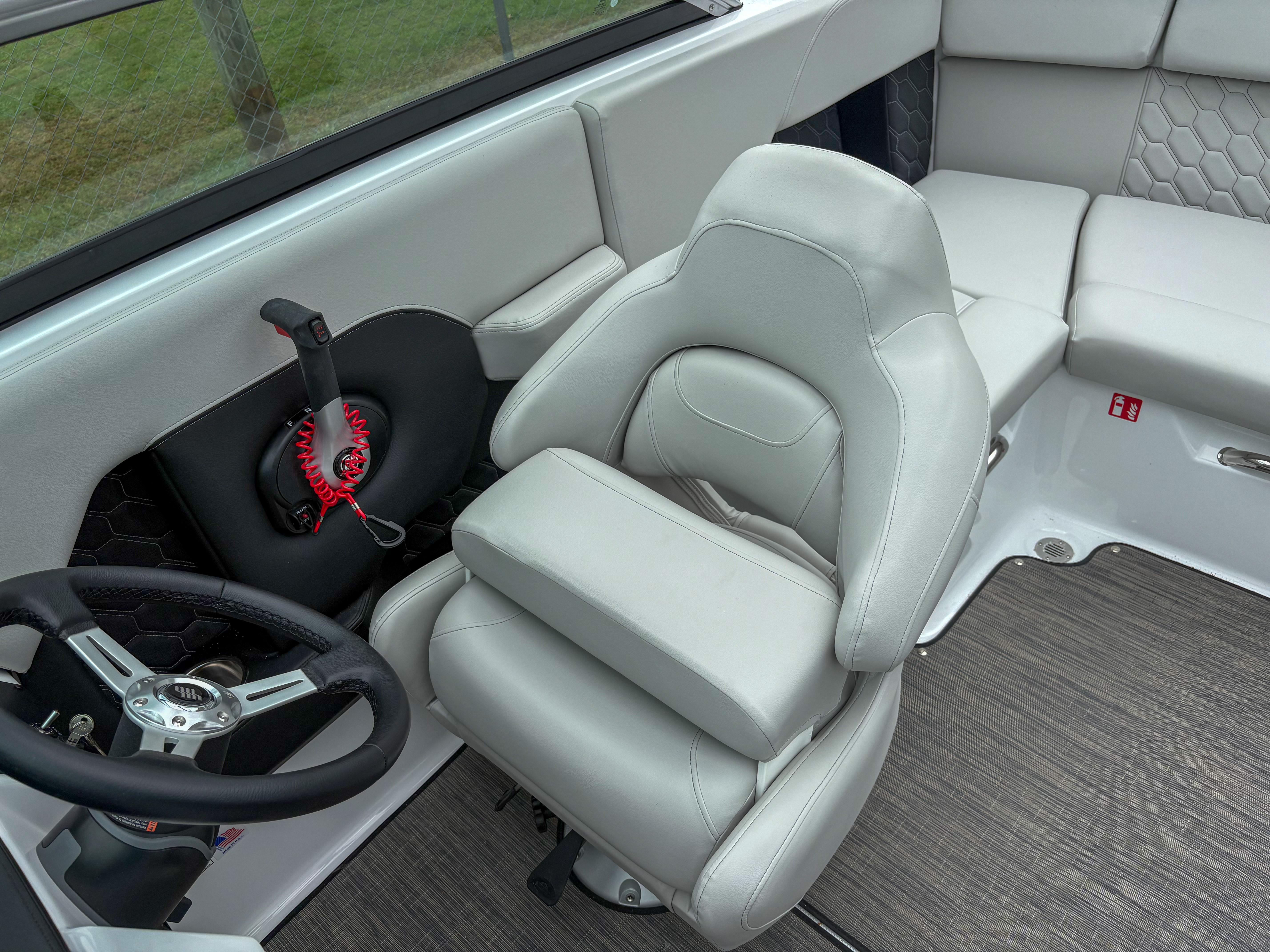 2026 Four Winns H2 Freedom boat interior with plush seating and modern steering wheel.
