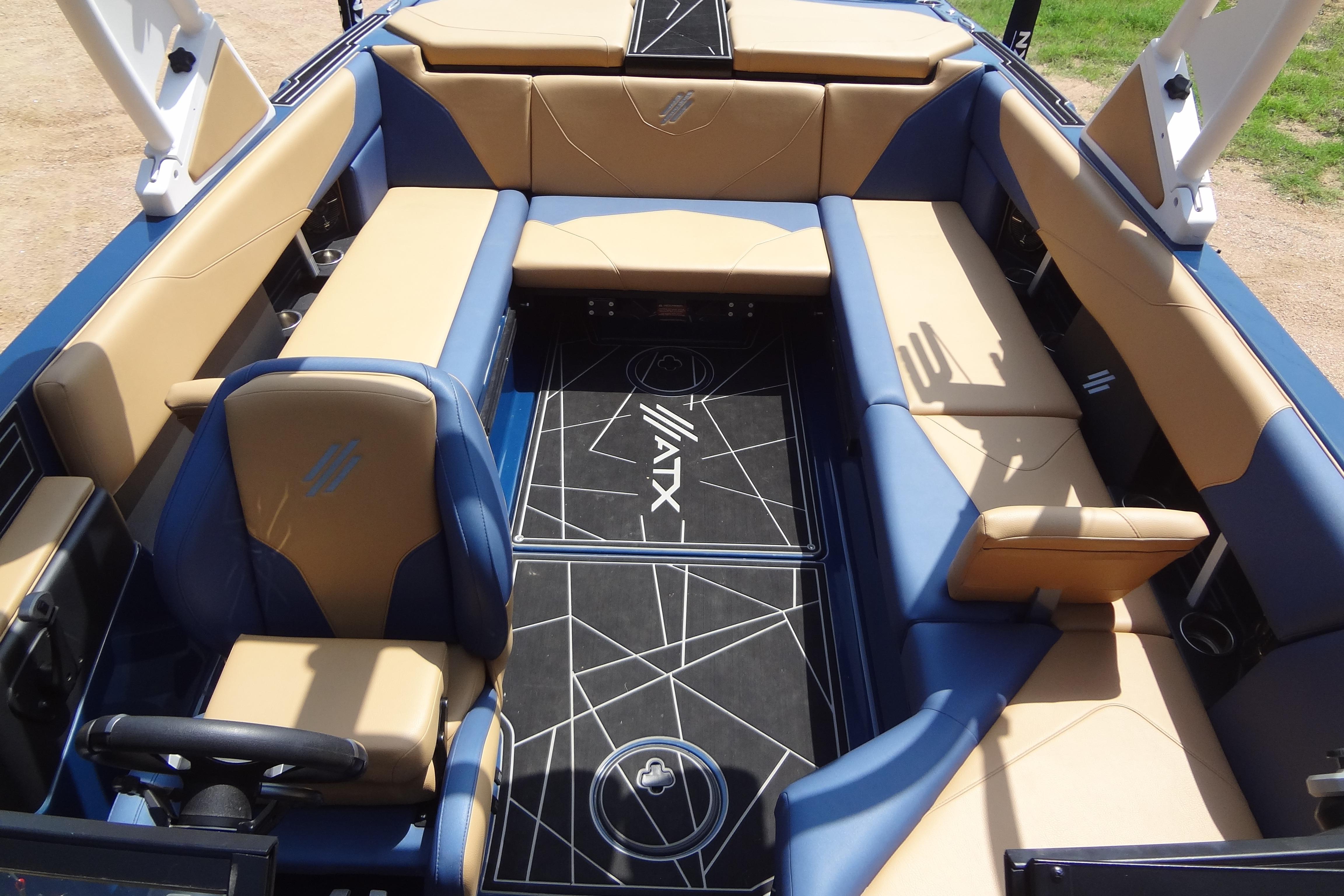Luxurious interior of 2022 ATX Surf Boats 24 Type-S with tan and blue seating.